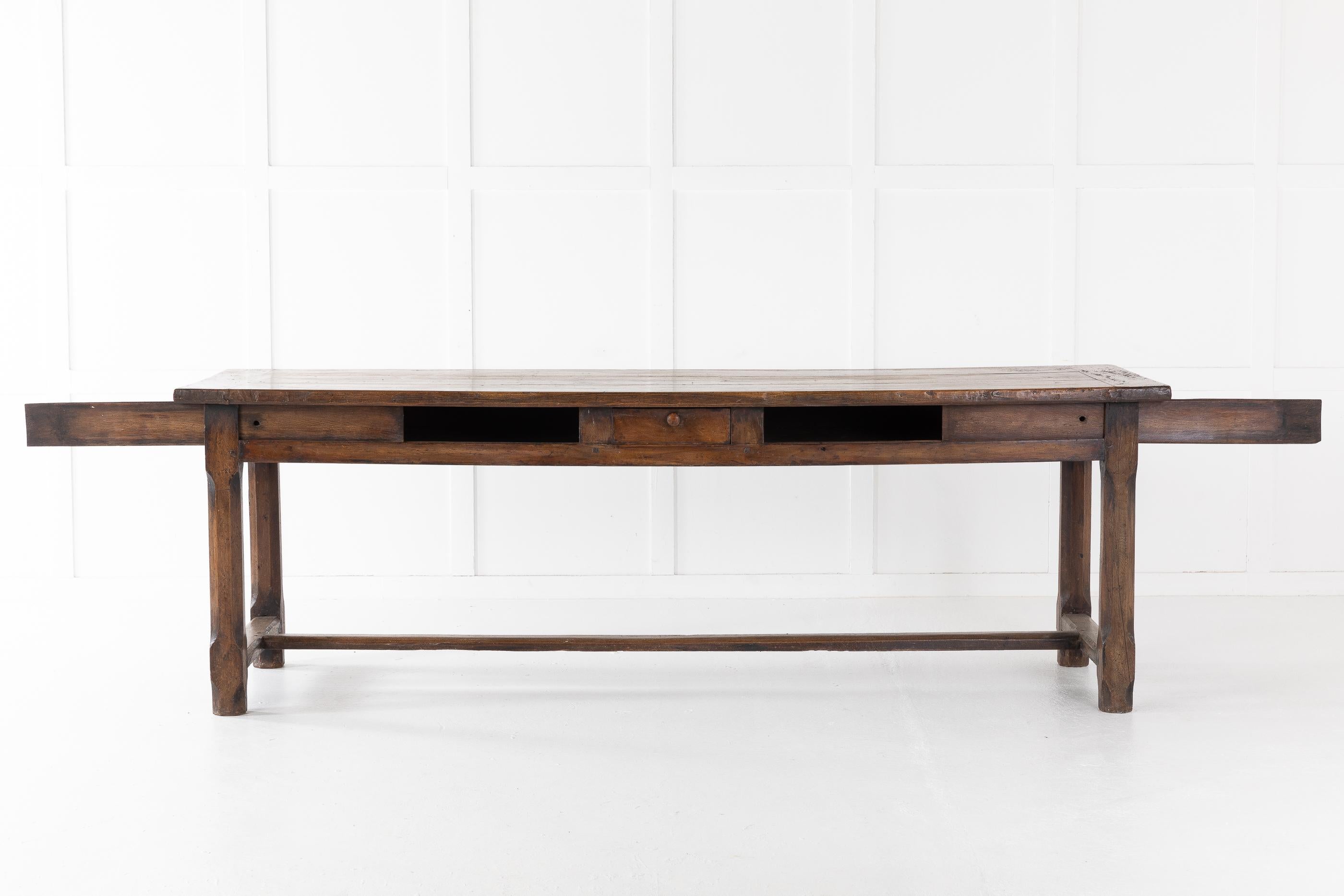 18th century French farm table in walnut of very nice color. The top is of three planks above two sliding panel drawers and one-center drawer.

Four posts support the sturdy table, fixed with a Classic 