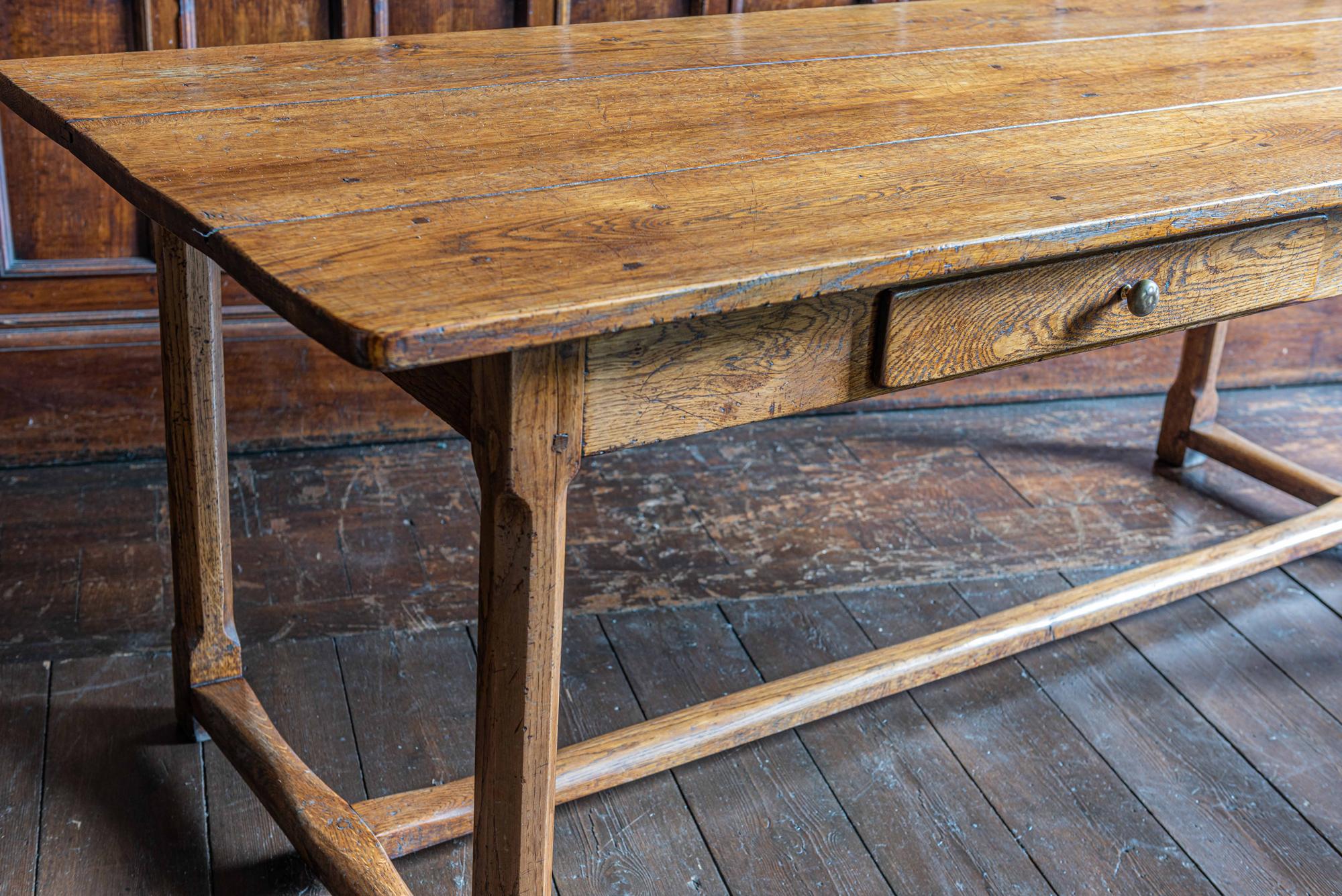 French 18th century oak farmhouse refectory table
circa 1780.

3 plank oak top with square oak pegs, warm oak color and centuries old patina and natural wear to the stretchers and top. A deep single cutlery draw dovetailed and solid oak lined off