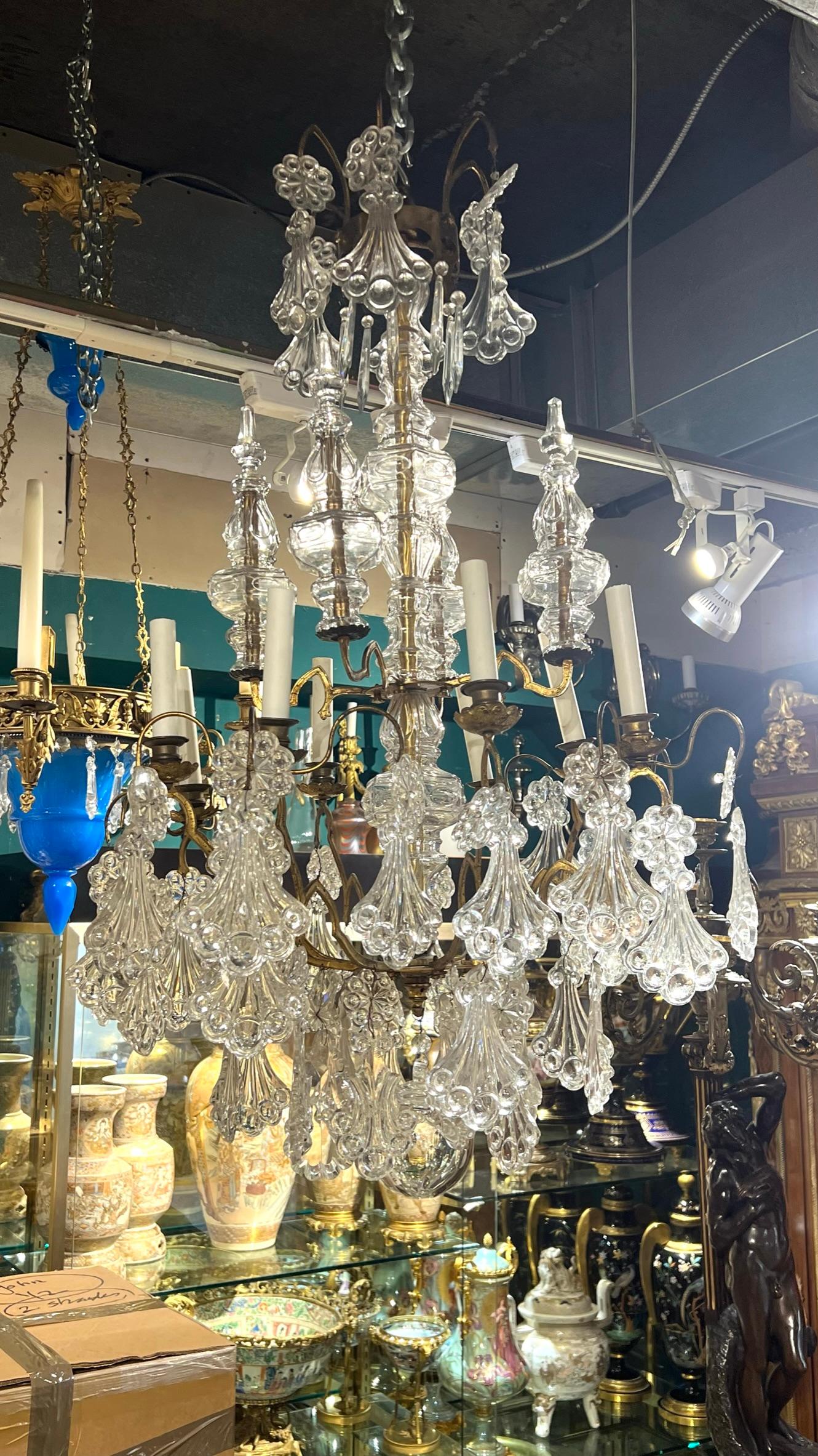 Fine bronze  12 light chandelier with numerous crystal pendants in the manner of Baccarat, measuring 40 inches by 24 inches.   With modern wiring and sockets, ready for installation.