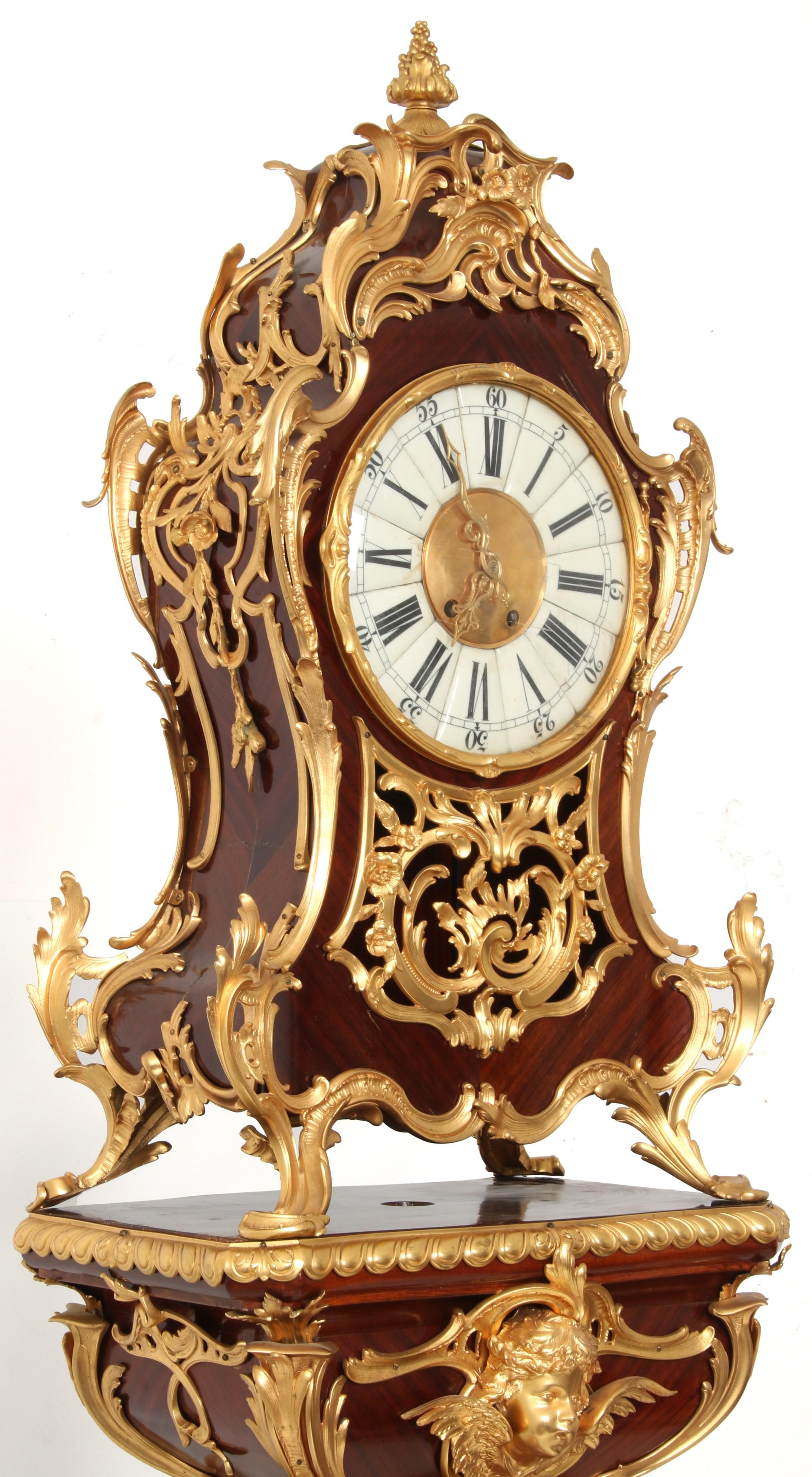 Finest quality palace size French 19th century Louis XV style gilt bronze mounted mahogany clock on pedestal.