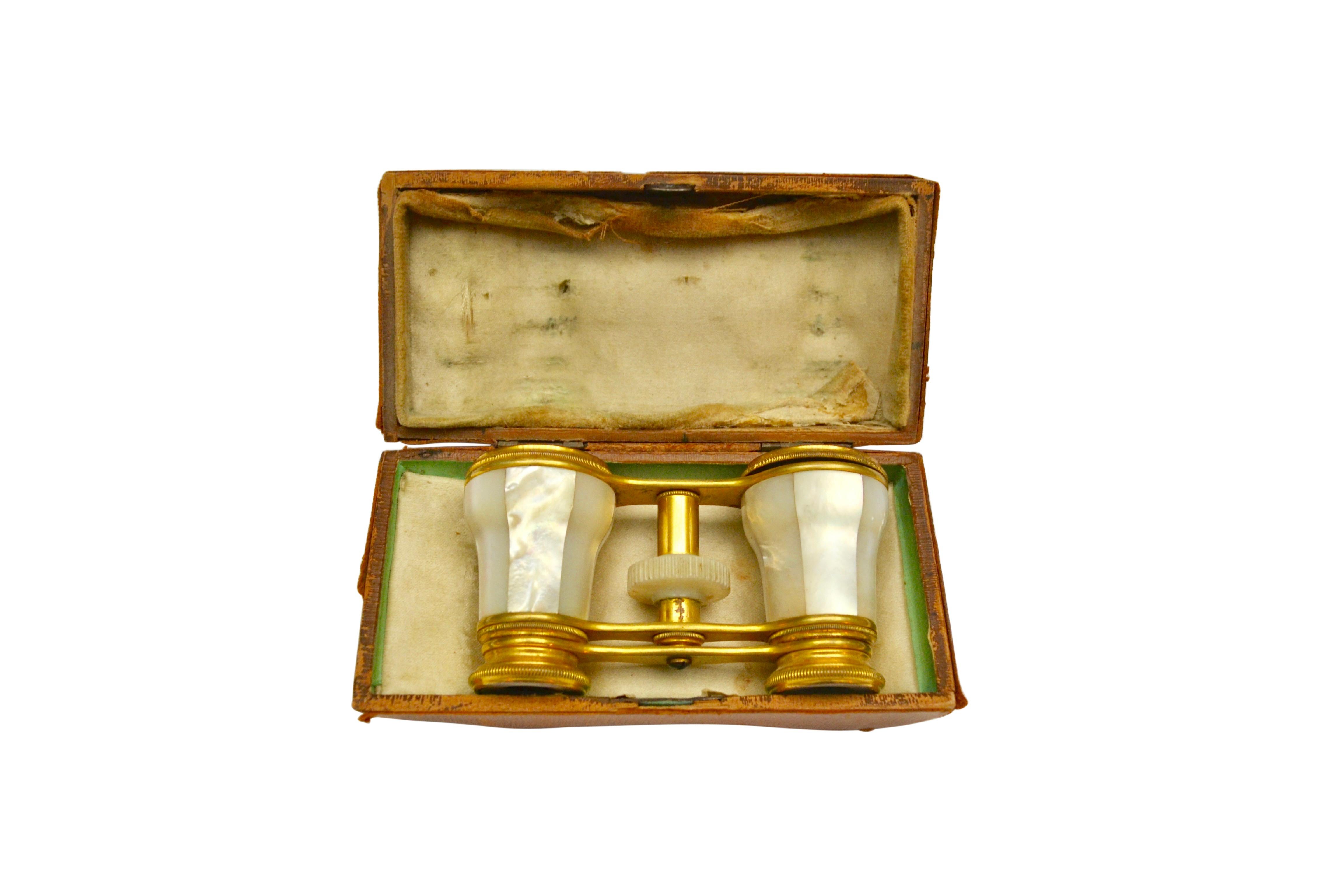 A simple yet very elegant set of Napoleon III French gilt bronze opera glasses richly finished in mother-of-pearl, a material which was all the rage especially in furniture n the late 19 century. The opera glasses are presented in their original tan