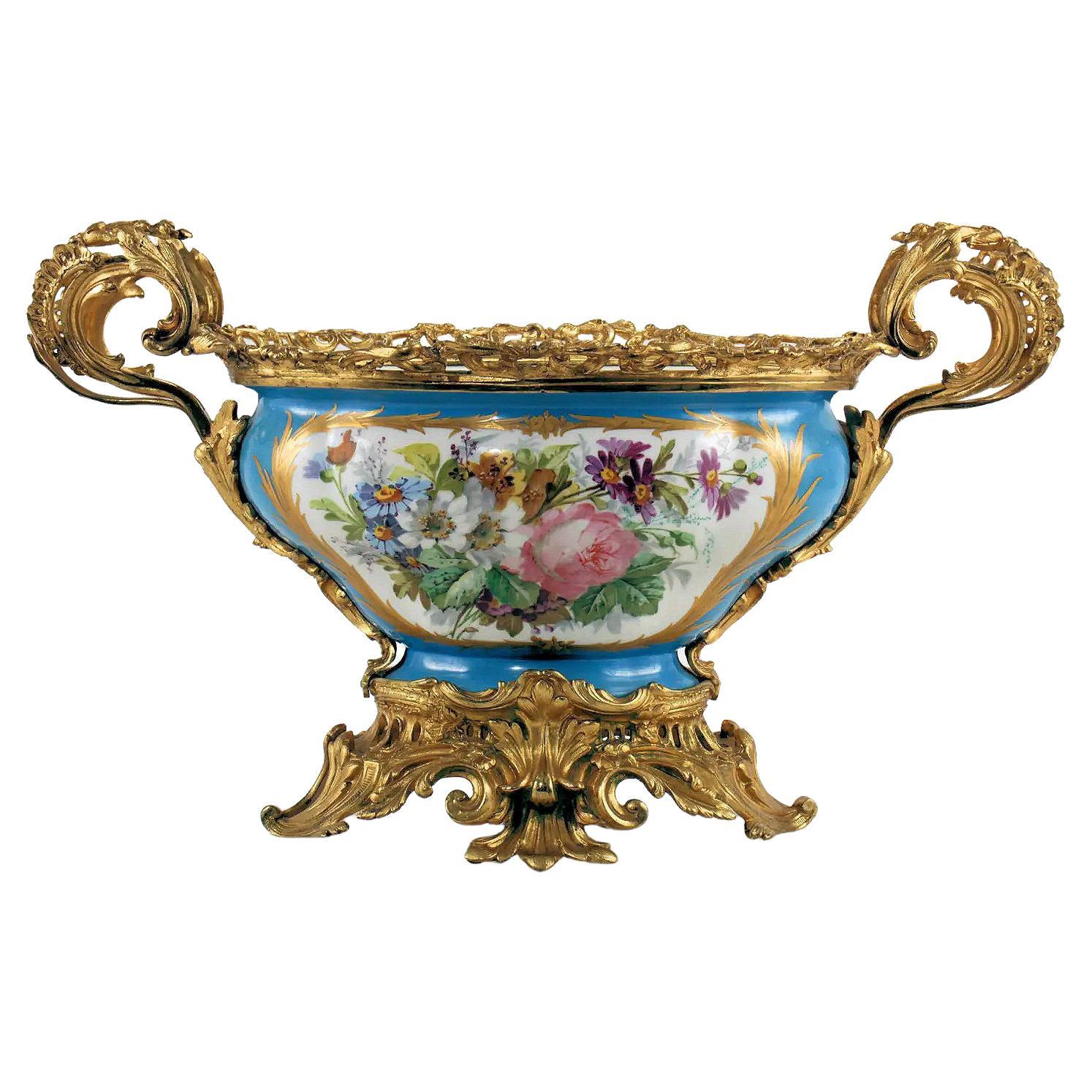Finest quality large French 19th century sevres style gilt bronze mounted hand painted celest blue porcelain centerpiece.
