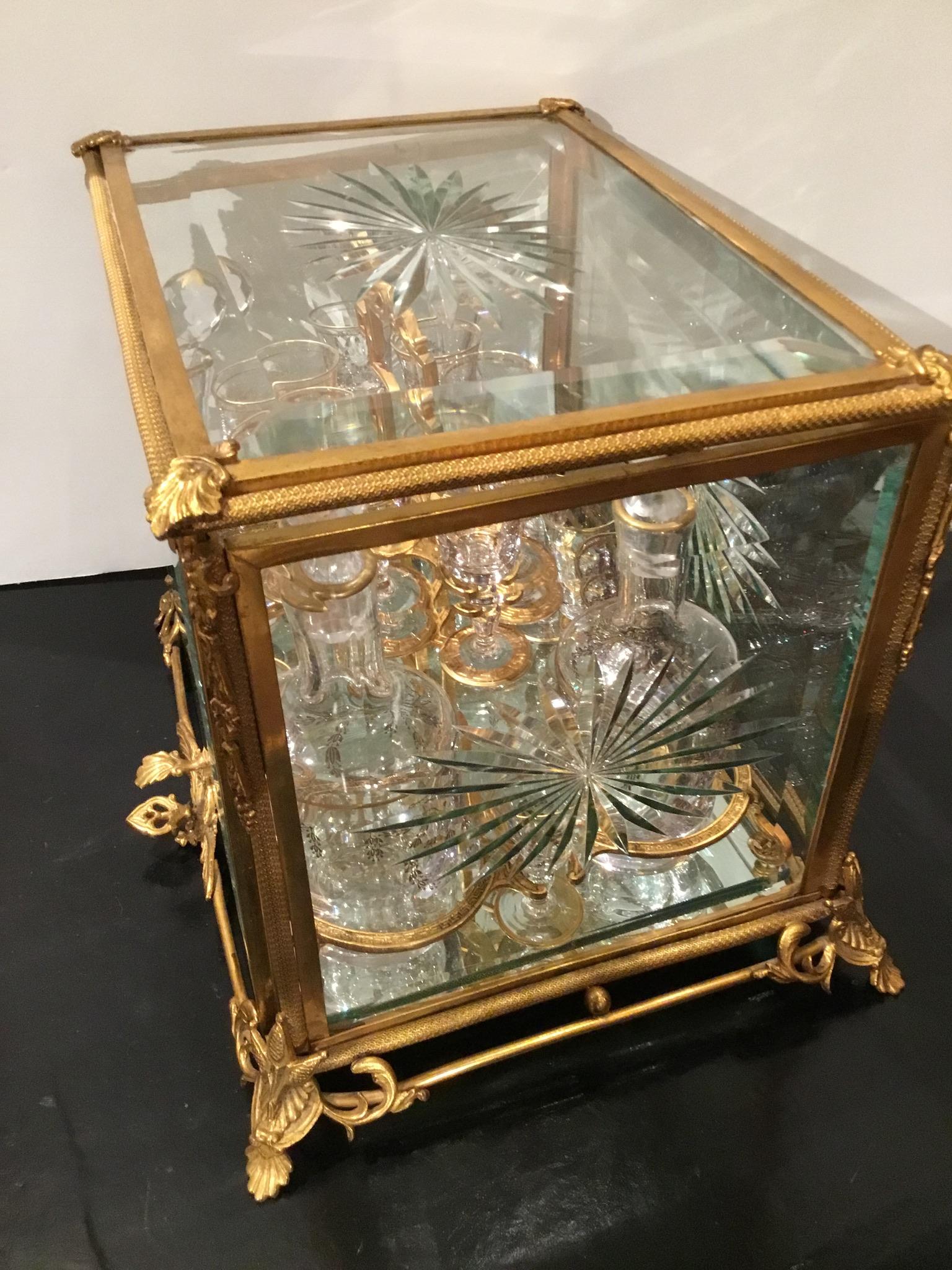 The Tantalus set is gilt bronze and glass  and is complete with
16 gold trimmed glasses and 4 gold trimmed decanters.
19th Century
