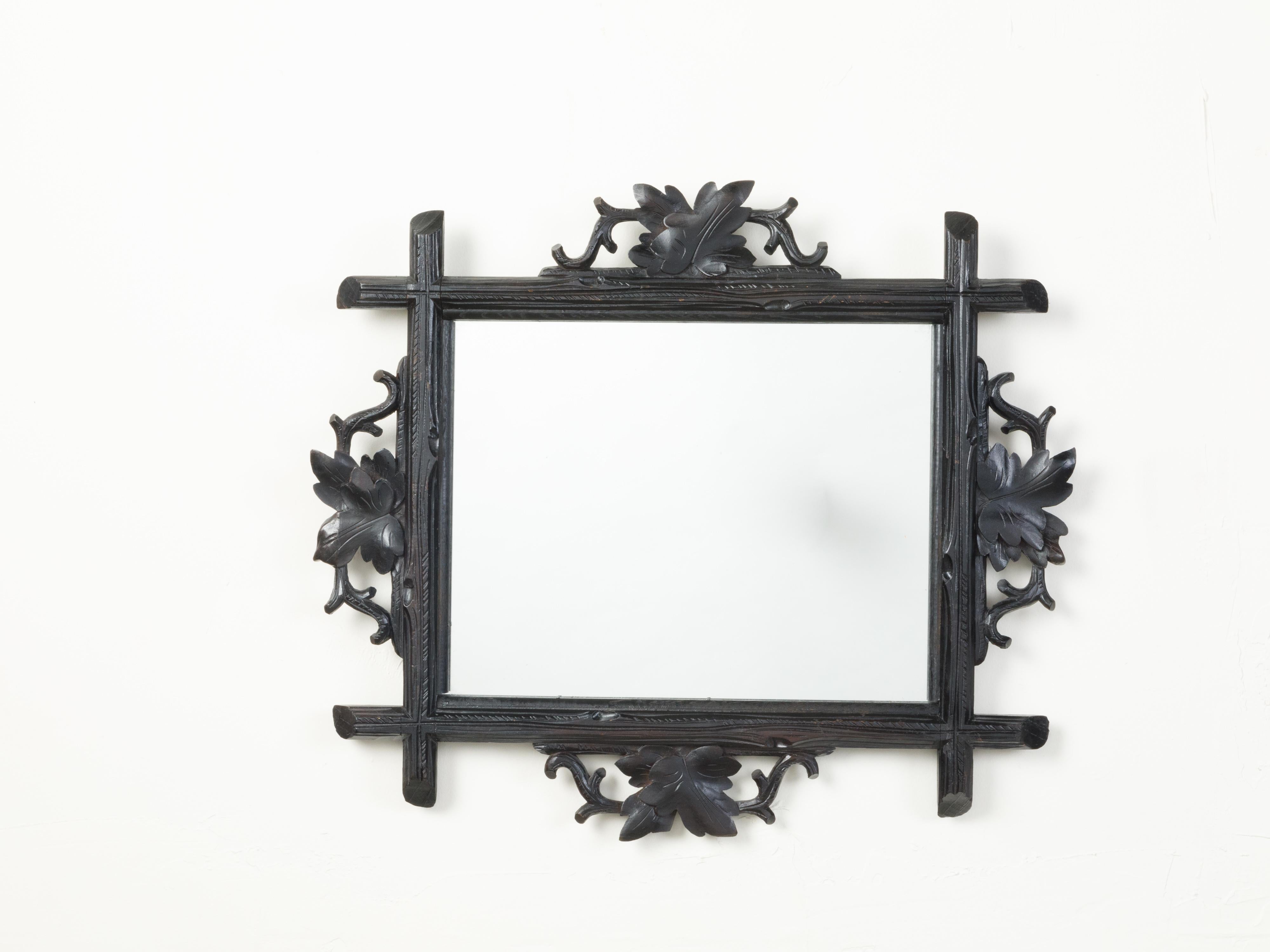 A French black forest mirror from the early 20th century, with hand-carved oak leaves. We currently have three mirrors available, priced and sold $1,350 EACH. Created at the Turn of the Century, this Black Forest mirror features a black frame made