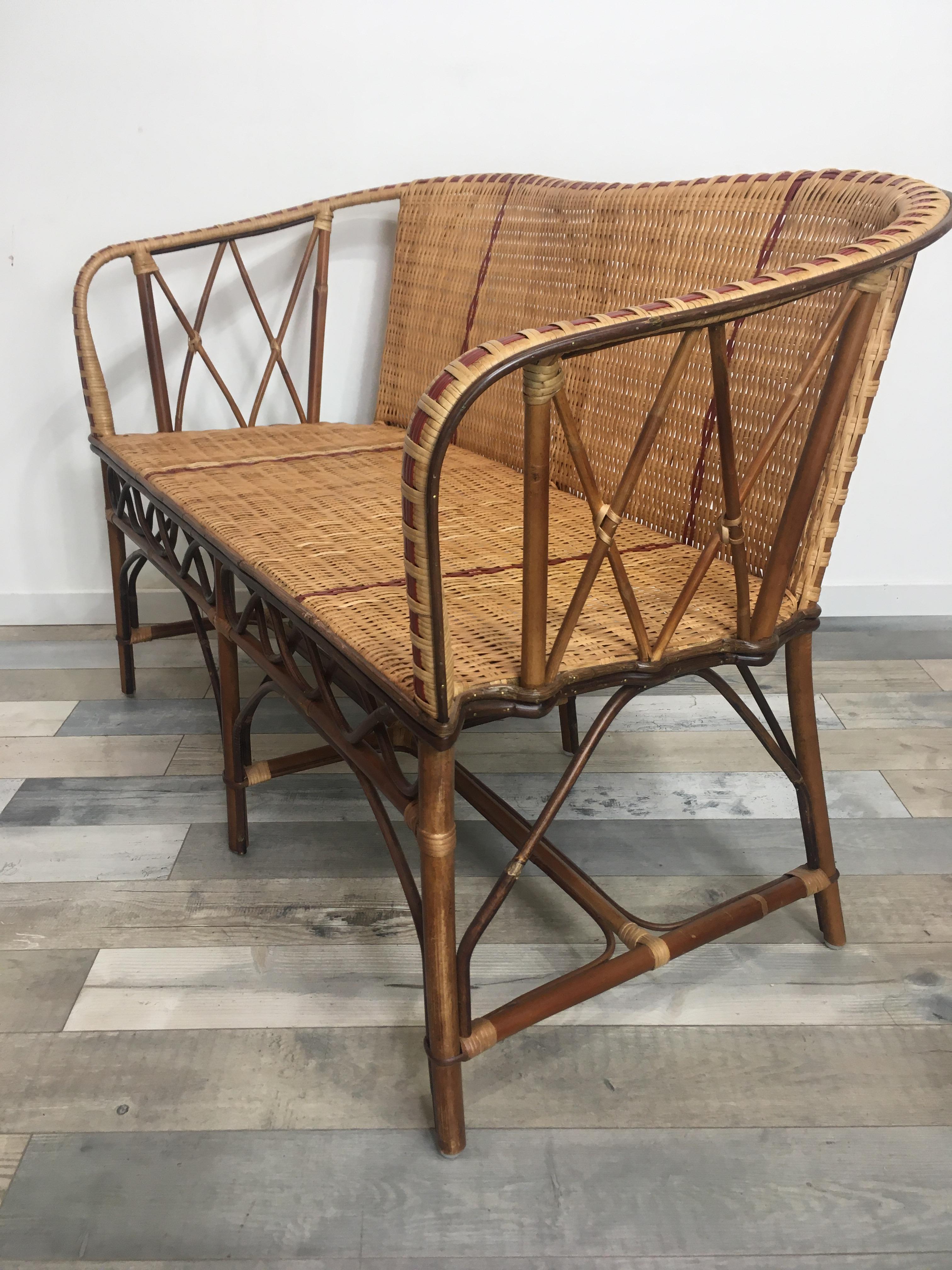 French 1900s Design Bistro Style rattan and braided wicker cane sofa composed of a rattan structure, braided rattan wicker cane with a red outline finish, famous at the beginning of the 20th century in Paris and their bistro terrace, it will be