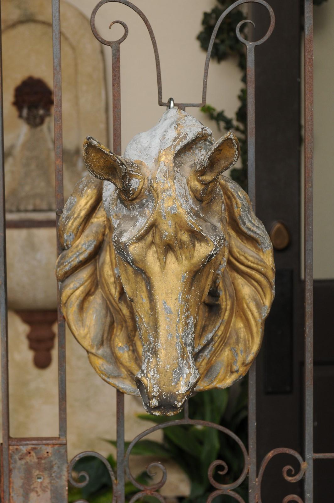 A French gilt zinc decorative horse head from the early 20th century with great details on the mane and musculature. Born in France during the Belle Époque era in the early years of the 20th century, this gilt zinc horse head strikes with its