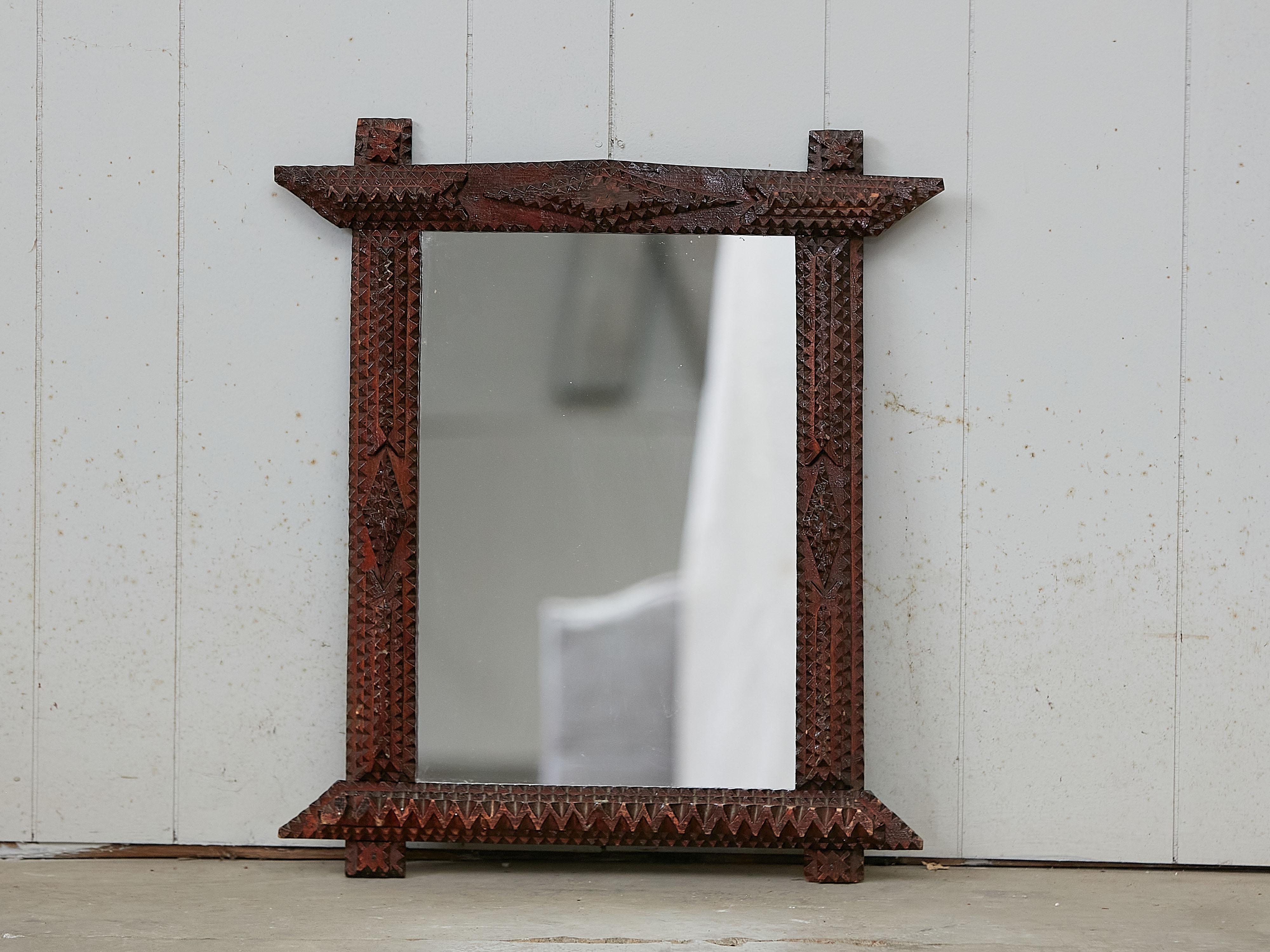 A French Tramp Art hand carved mirror from the early 20th century with raised diamond motifs. Created in France during the early years of the 20th century, this mirror was hand carved in the manner typical of the Tramp Art style. Consisting of a