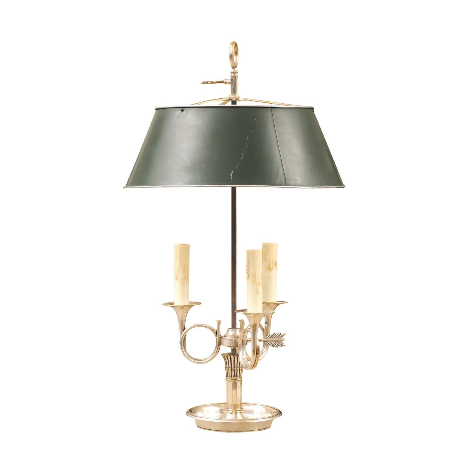 A Turn of the Century silvered bronze three-light bouillotte table lamp from the early 20th century with French hunting horn-themed arms and green painted sheet metal shade. Created in France during the Turn of the Century which saw the transition