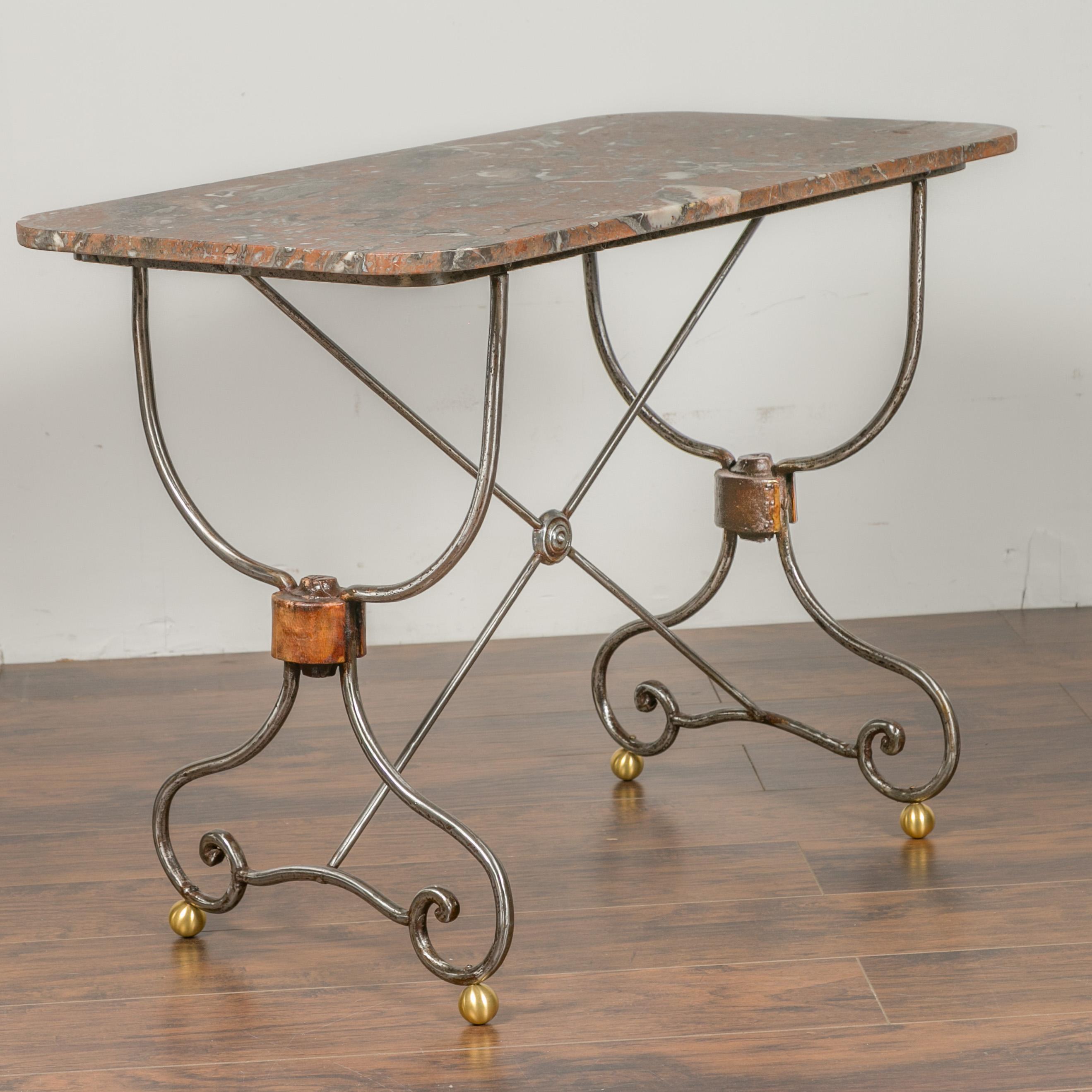 A French steel and brass console table from the early 20th century, with variegated marble top and scrolling feet. We have a twin table available, see item LU836719327322 should you need a pair. They are priced and sold individually. Born in France