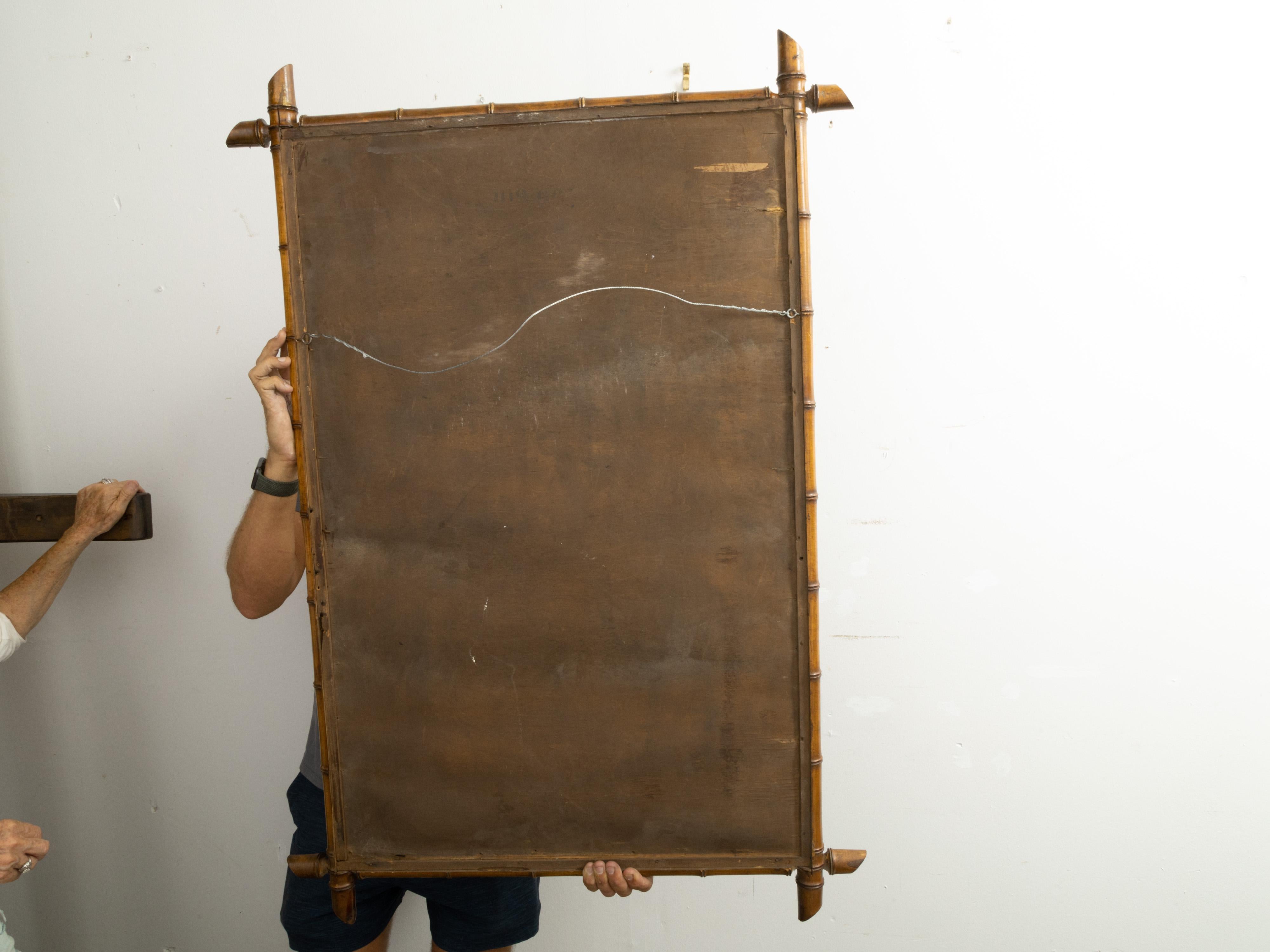 A French rectangular faux-bamboo mirror from the early 20th century, with light brown patina. Created in France during the early years of the 20th century, this rustic Turn of the Century mirror features a rectangular silhouette made of a thin faux