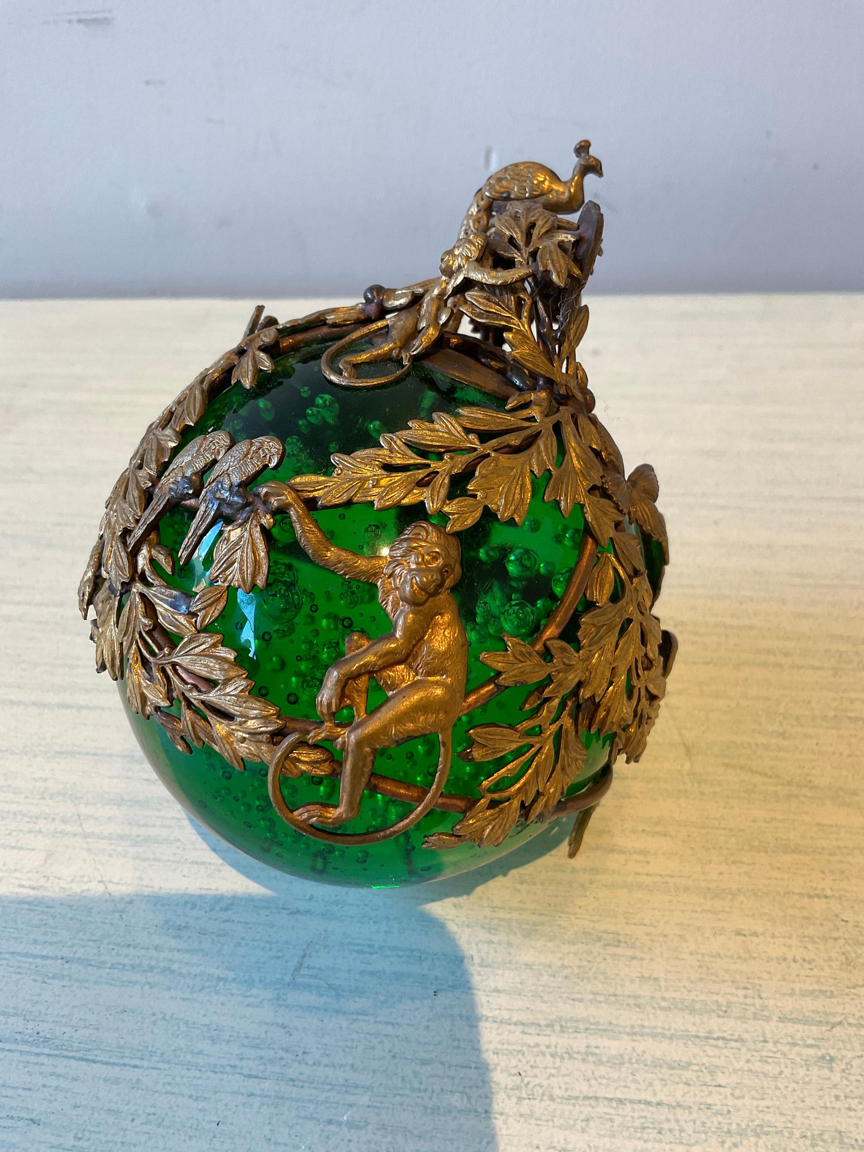 French 1910 green bubble glass ornament with brass ormolu of a Monkey, parrot, snake, peacock and a butterfly. Would look great on a base.
Signed, but can’t make out the signature as seen in the last picture.