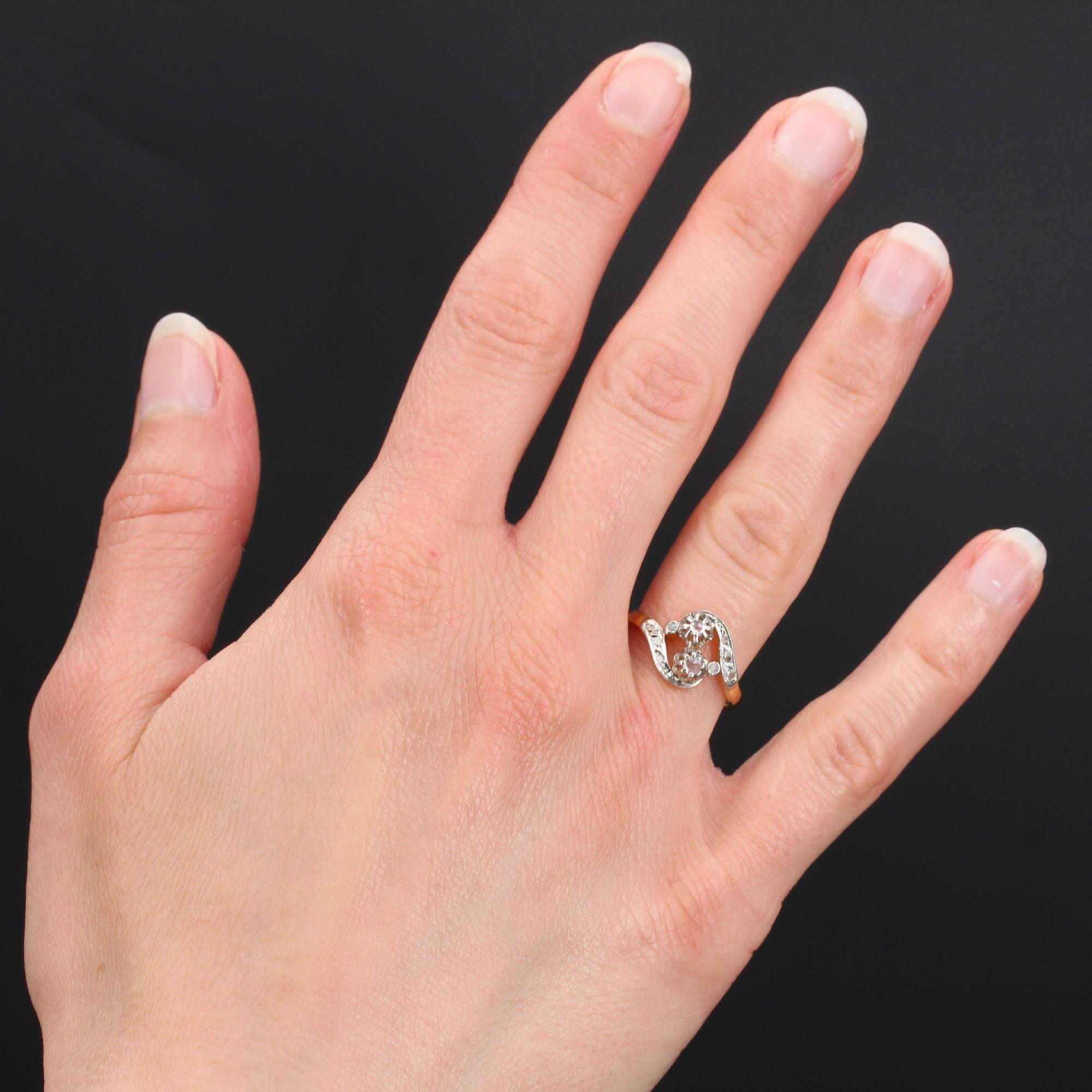 Ring in 18 karat yellow gold, and platinum.
Charming antique ring, it is constituted of a motive called you and me, set with claws of 2 rose- cut diamonds. On either side, asymmetrically, a curve set with rose-cut diamonds gives the start of the