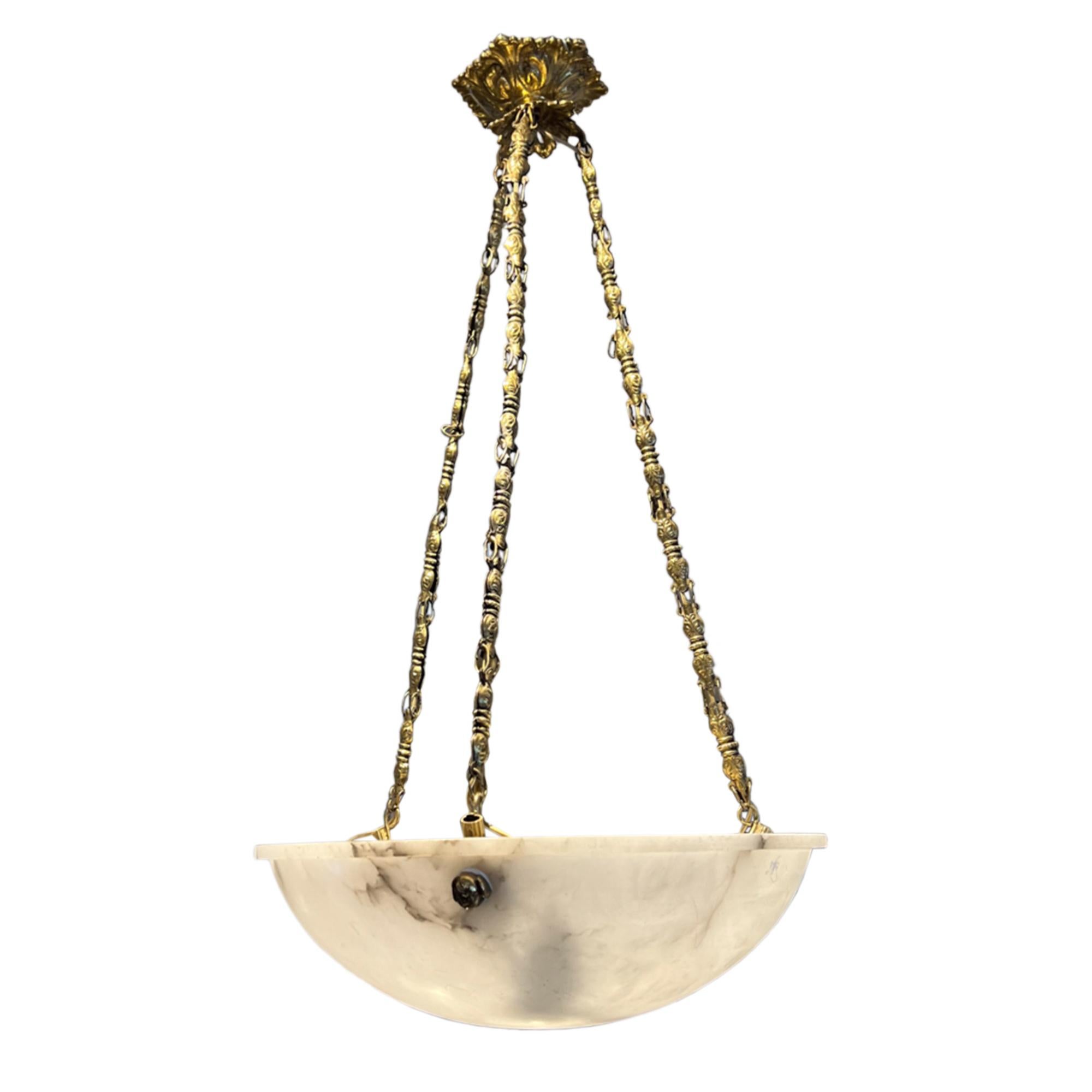 This is a fantastic Art Deco hanging light. It's made from alabaster with the three brass hanging chains secured with roses heads. 

Please take a look at all our pictures to see the lovely marbling and patinated brass chain.

 Classically