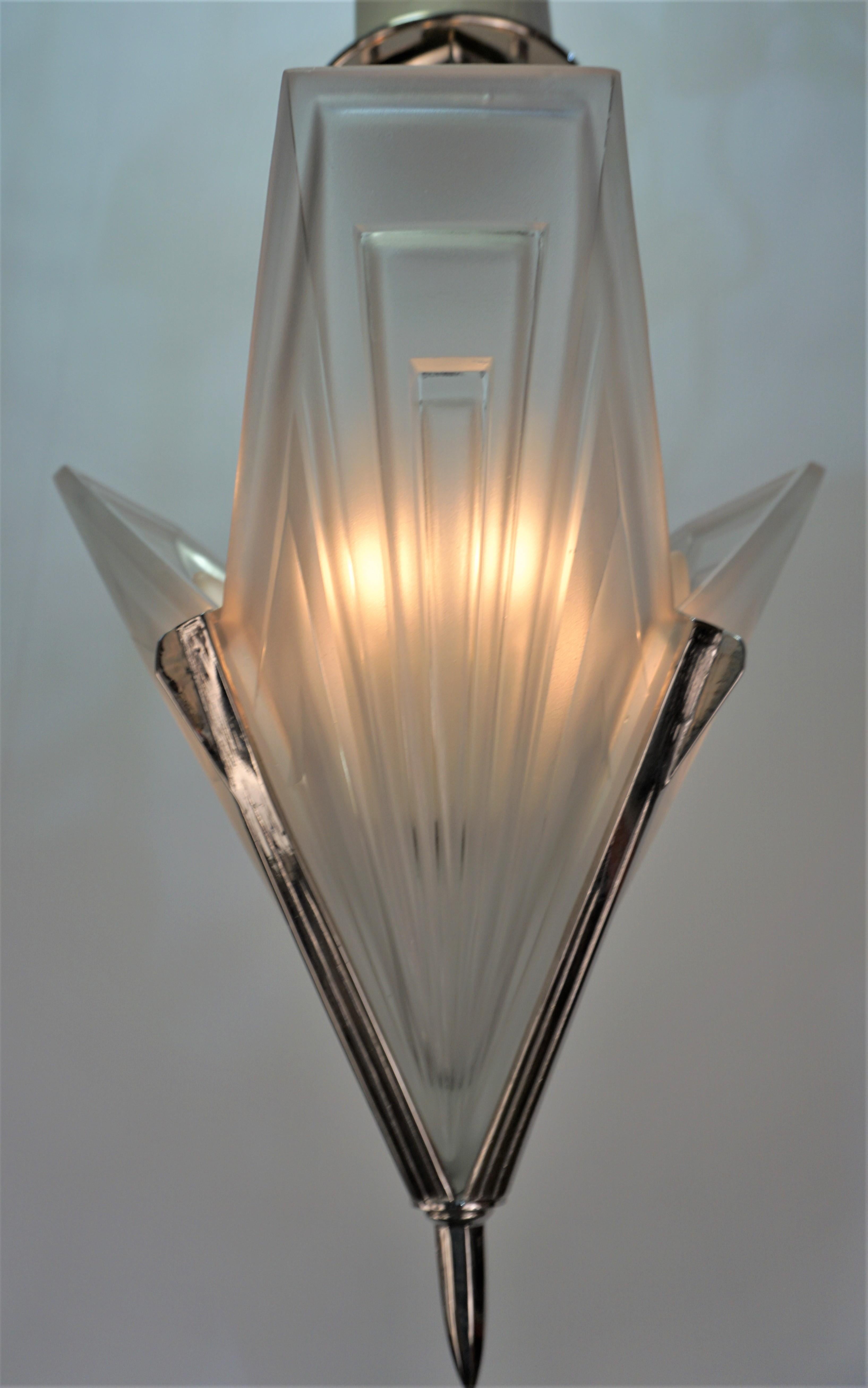 Clear frost glass with nickel on bronze frame art deco chandelier.
Six lights 60 watts each.