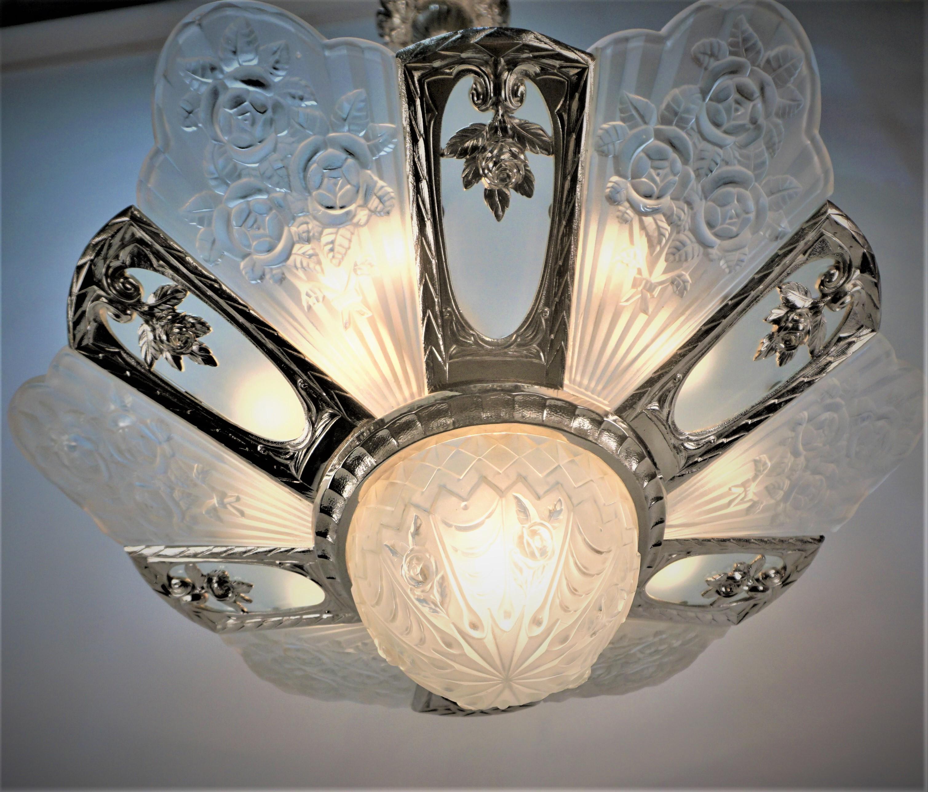 Six molded clear frosted glass with scalloped tops bearing rose with additional six flat frosted insets and a deep matching central coupe mounted in a fabulous, polished nickel over bronze Frame. 
13 lights 60 watts max each.
 