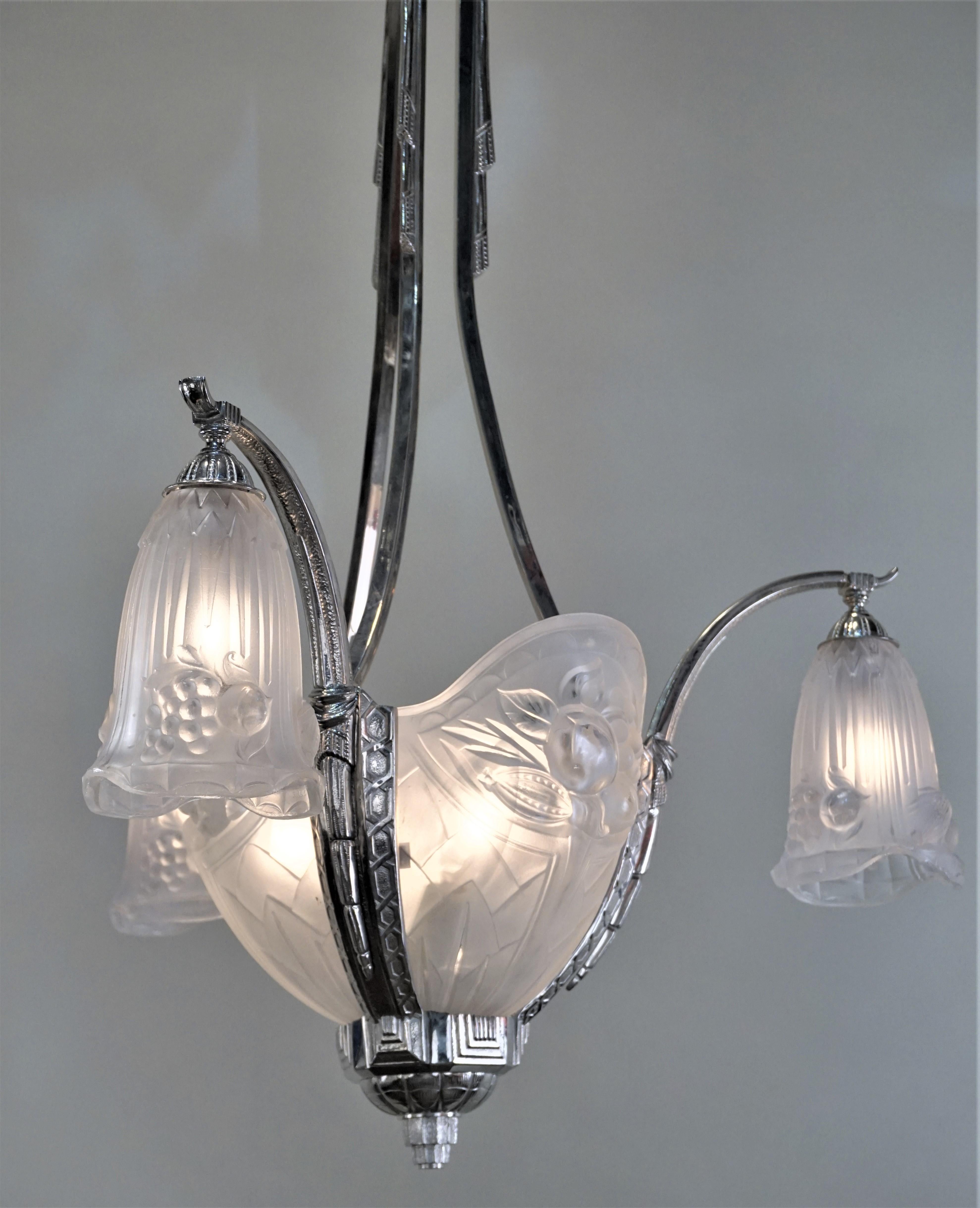 Fabulous nickel on bronze with beautiful clear Frost molded glass Art Deco chandelier by P. Gills.
Total of 9 lights 60 watt max each.