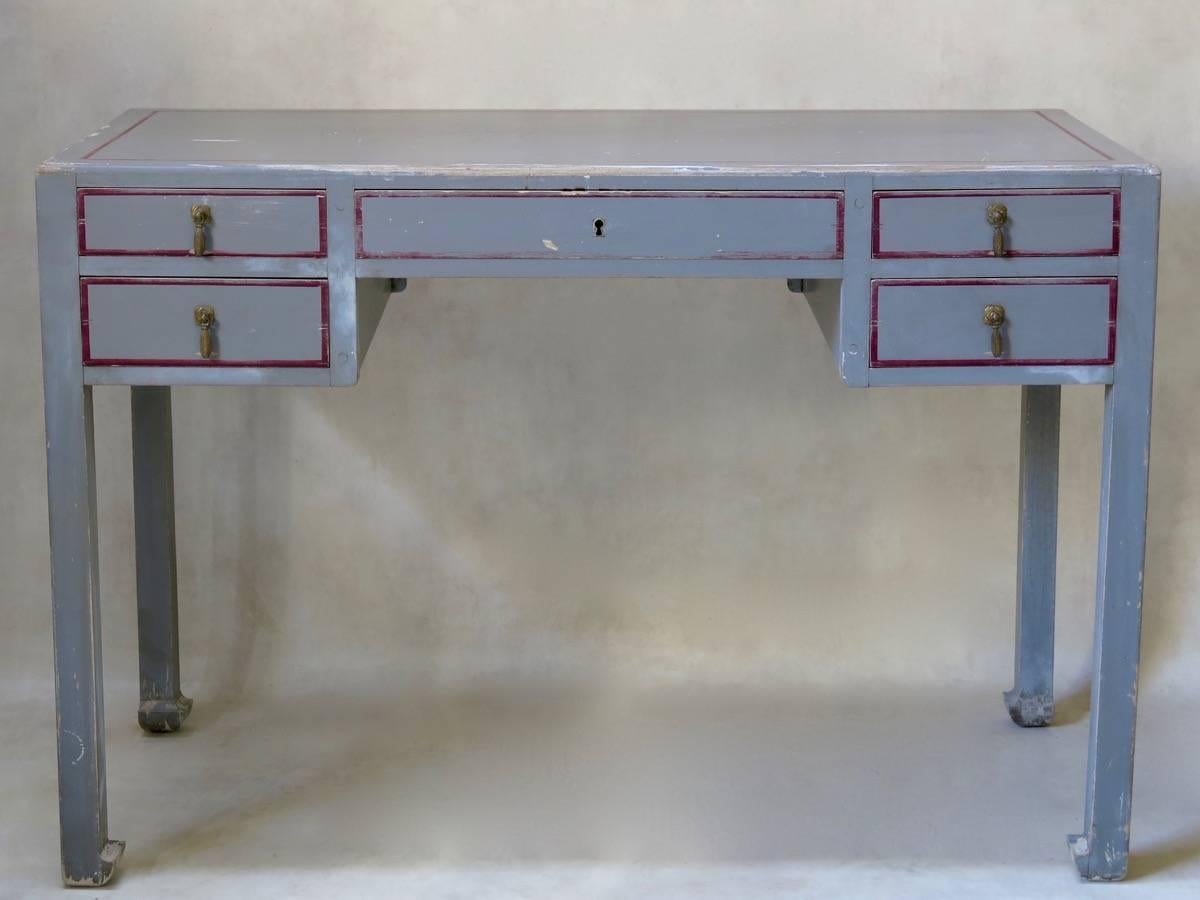 Art Deco desk attributed to Paul Poiret's fashionable furniture-making firm, Atelier Martine. Painted a soft grey color, with contrasting, deep red. Raised on Chinese-style block feet.