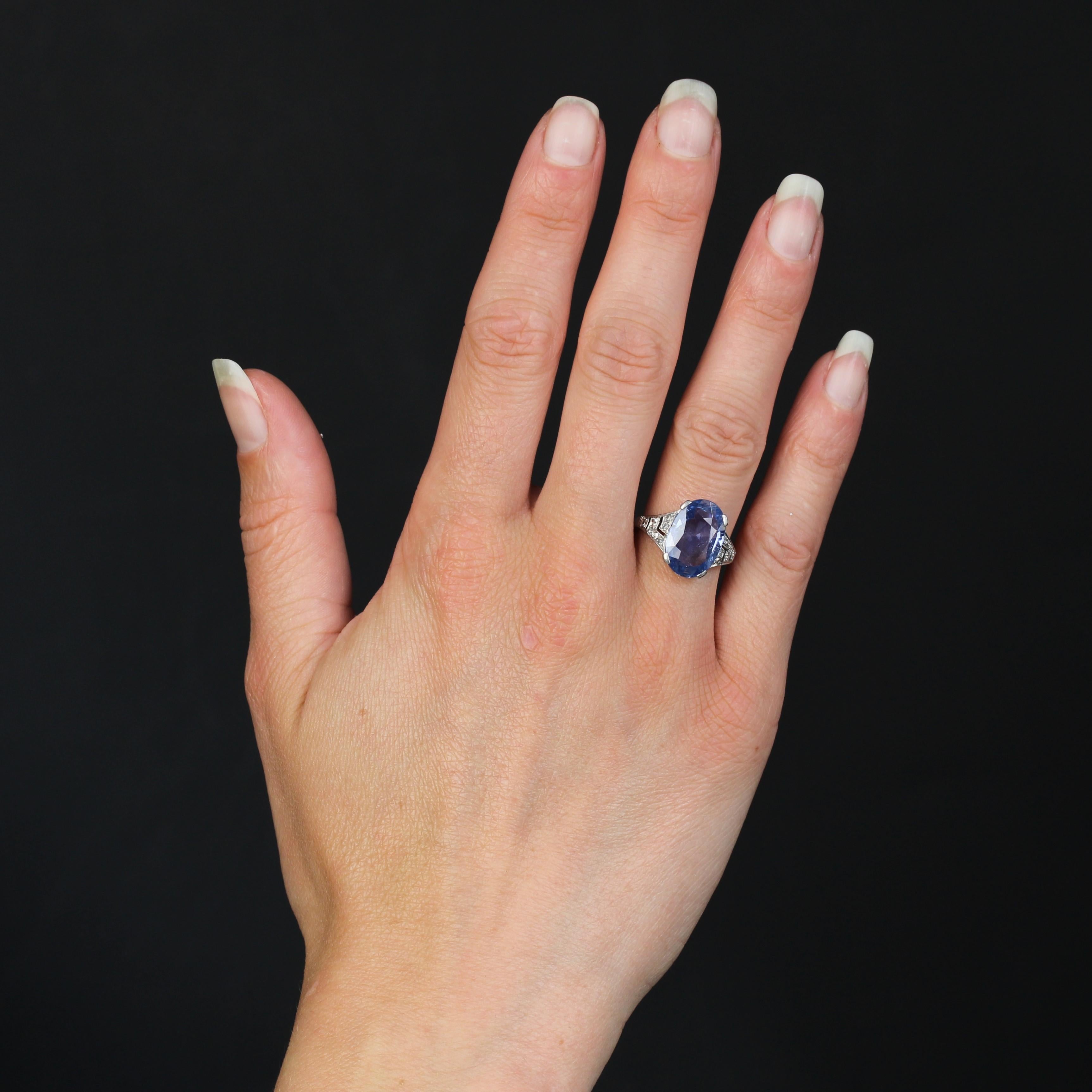 Ring in platinum ring, dog head hallmark.
A sublime Art Deco ring, its platinum setting follows the curve of the finger and holds a large oval Ceylon sapphire of soft blue brilliance in 4 flat claws at the top. On either side of the sapphire, the