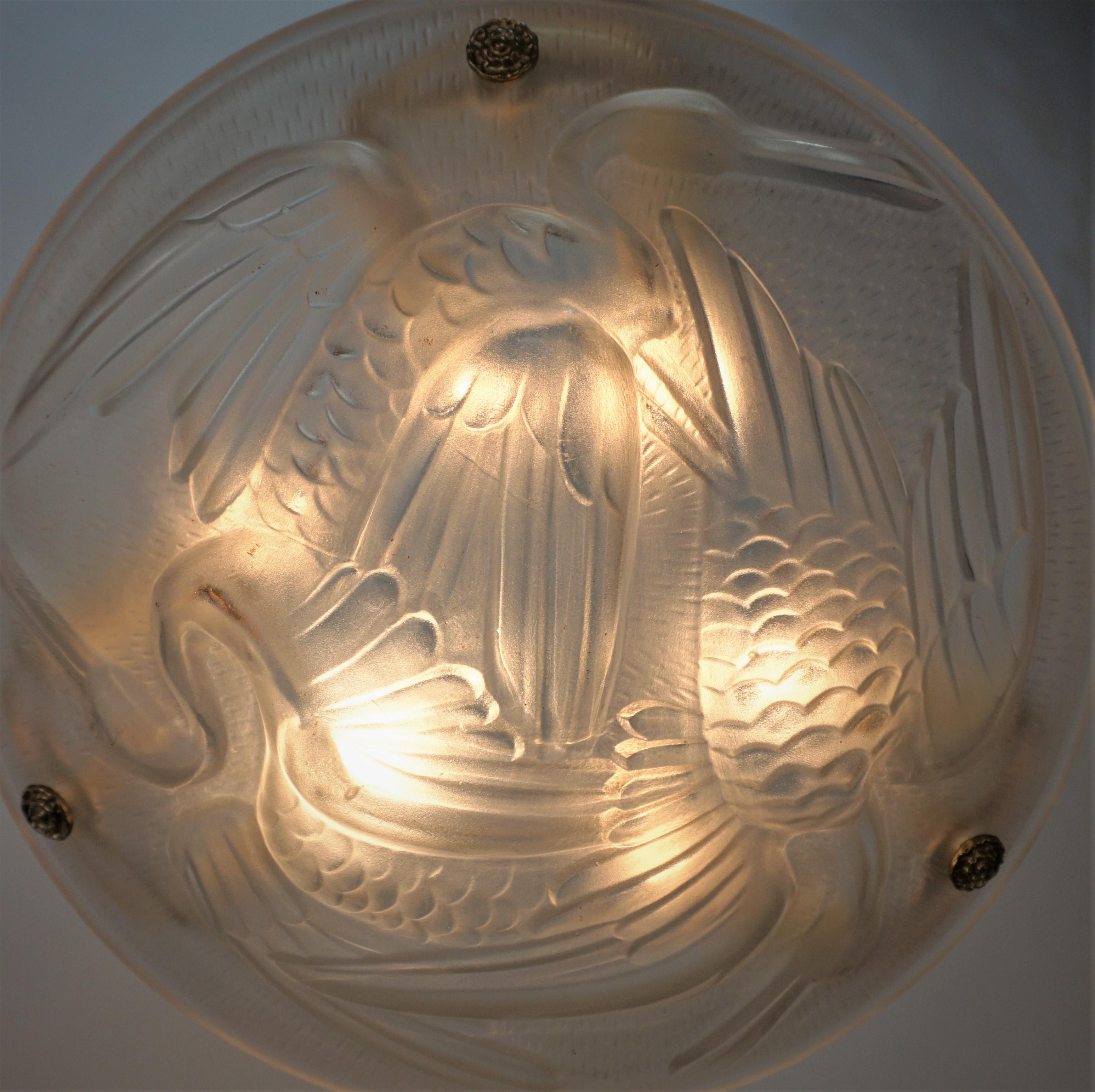 Clear frost glass 1920's art deco with three storks has bronze chain and canopy pendant chandelier. Two in stock.
Six lights, 75max each.
