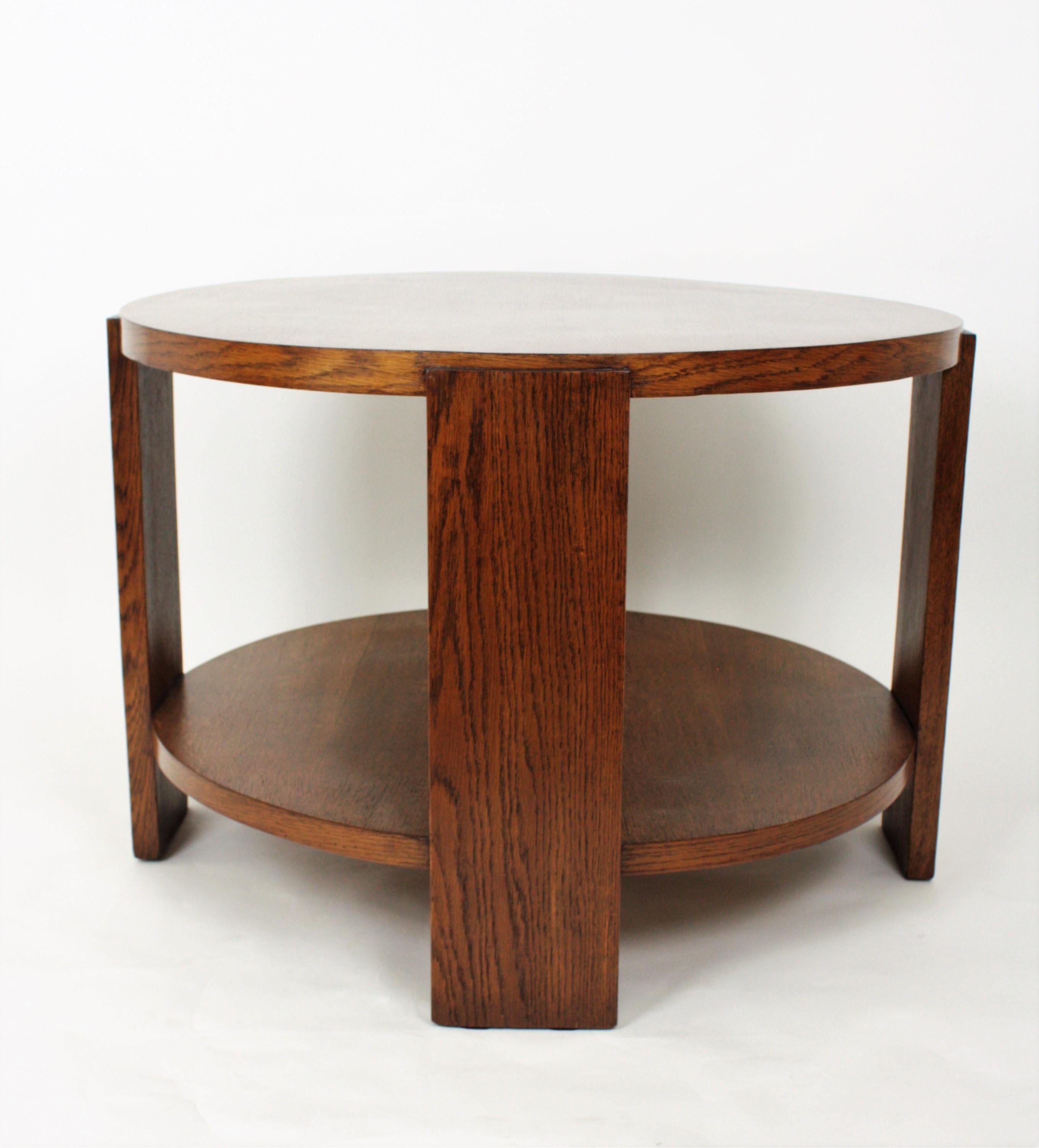 Stylish oak wood Art Deco table with two levels and a beautiful design with a shelf and supported by four round top side supports.
This table has been carefully restored and varnished using traditional methods. Lovely to be used as coffee table,