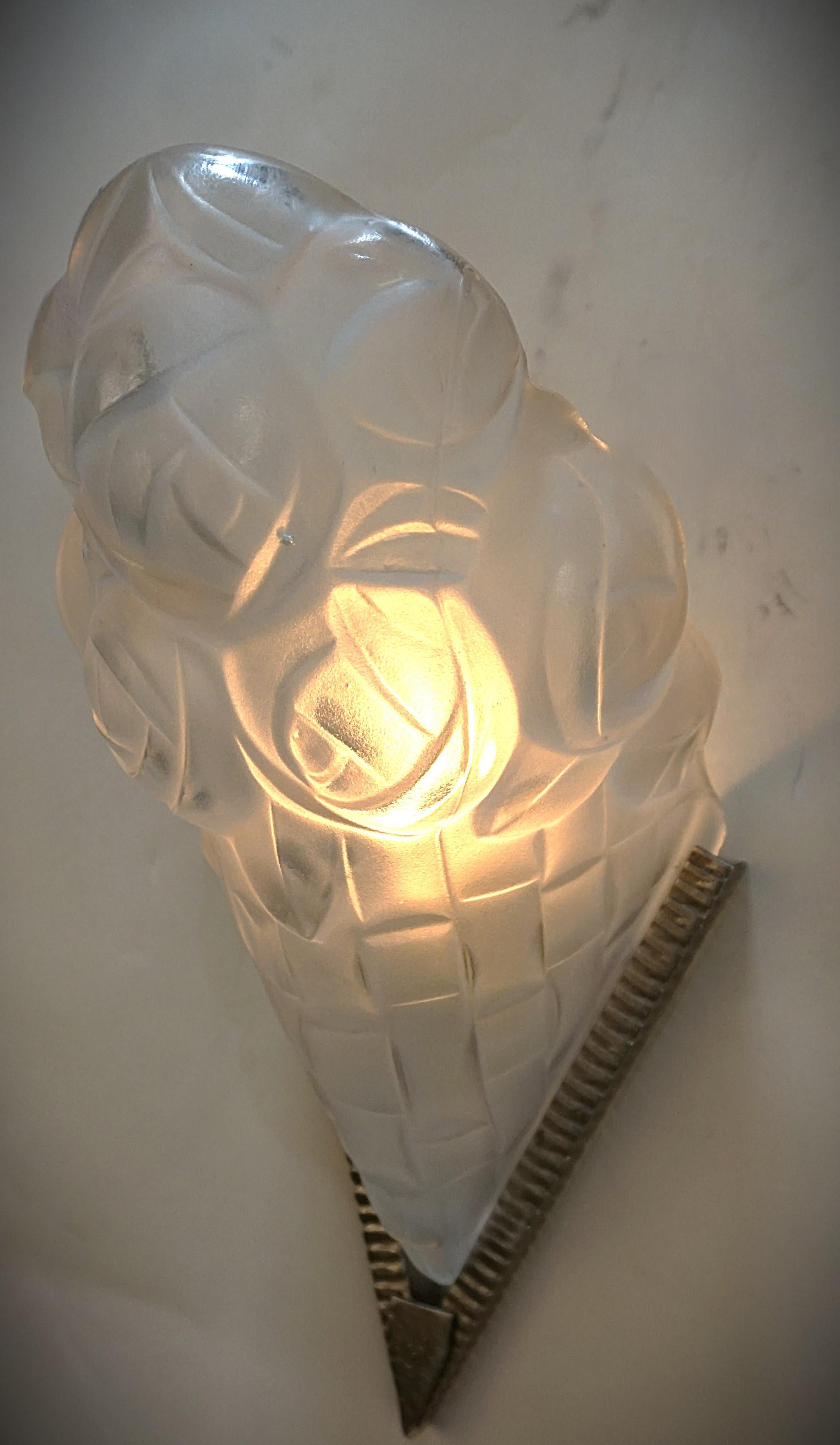 Pair of clear frost glass and satin nickel finish on hand made iron frame art deco wall sconces by Degue.
Professionally rewired and ready for installation.