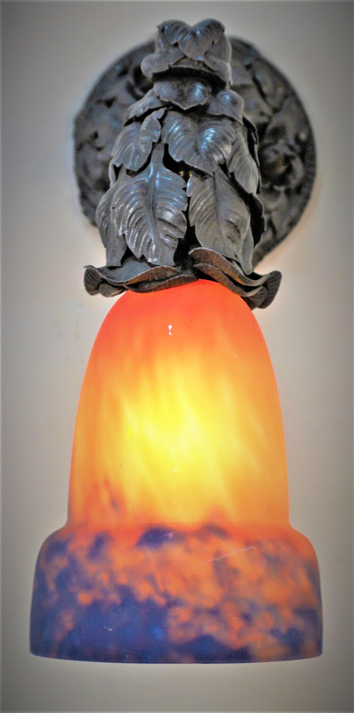 Beautiful 1920s blown glass shade and handmade iron work frame wall sconce.