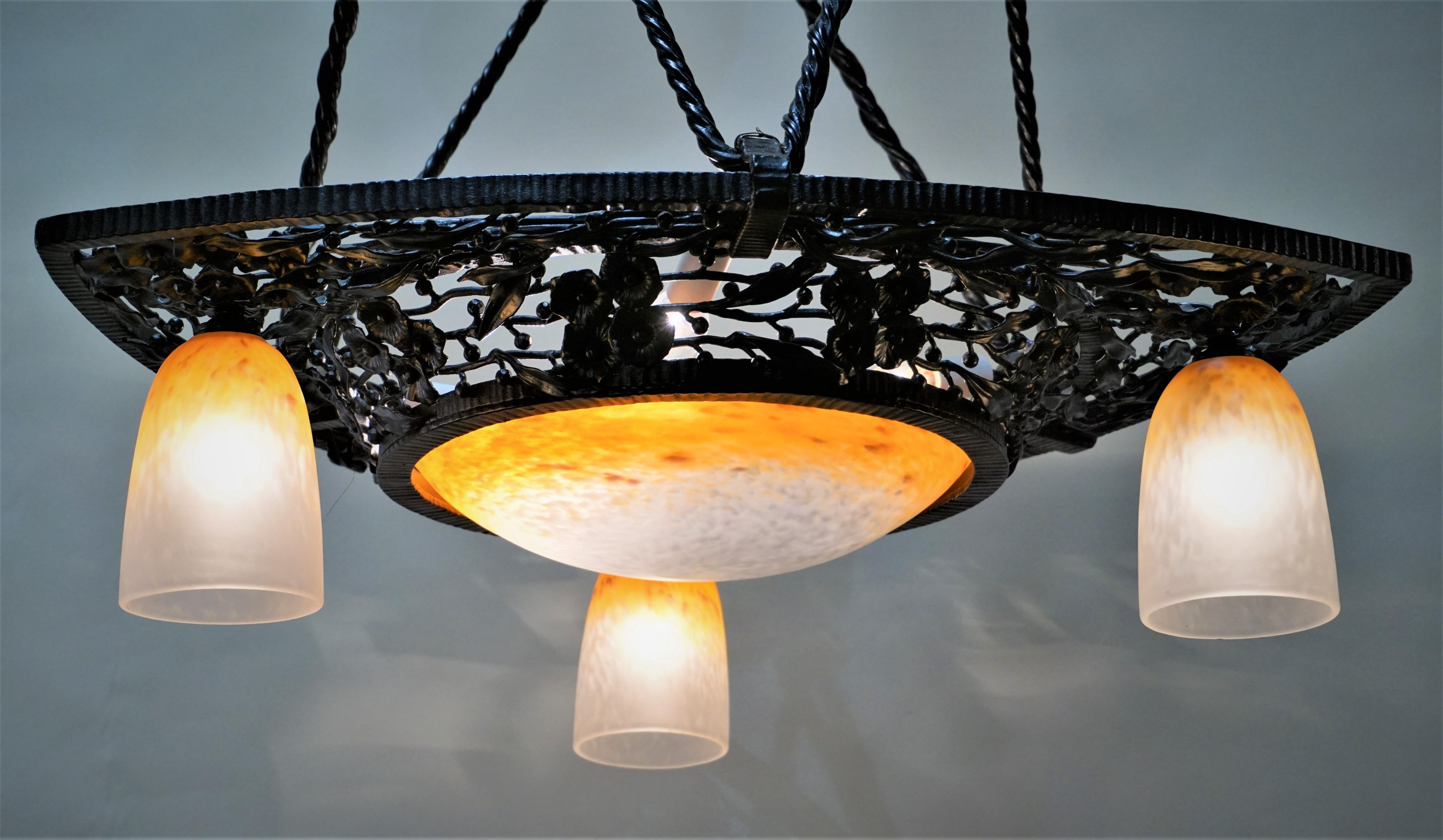 Wrought iron and blown glass shade chandelier by Charles Schneider.
Total of seven lights 60 watt max each.