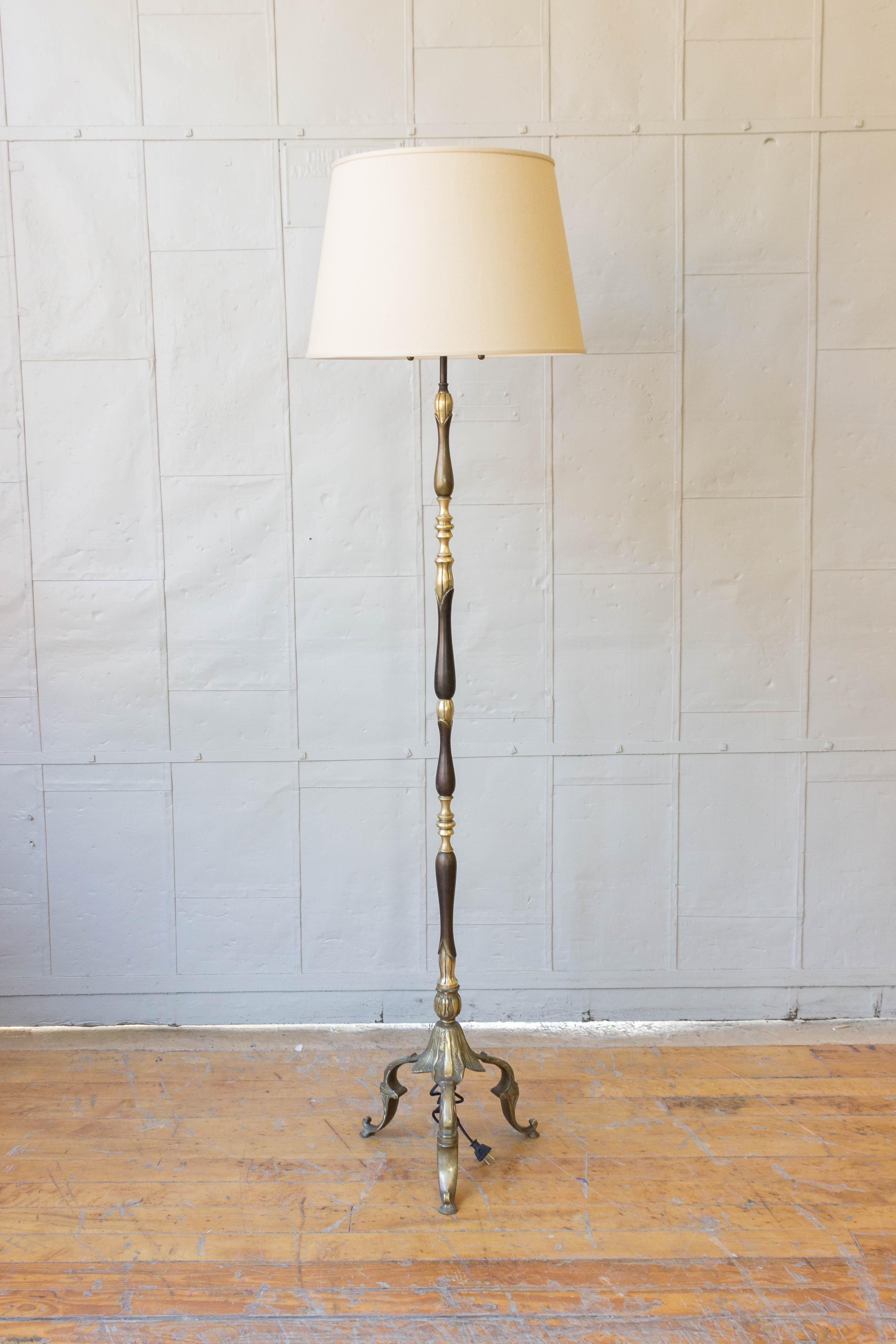 French 1920s patinated and two toned floor lamp on a tripod base. The lamp has recently been rewired and has two sockets. Custom black feather shade by ABYU Lighting, shade sold separately. 

Shade sold separately. 