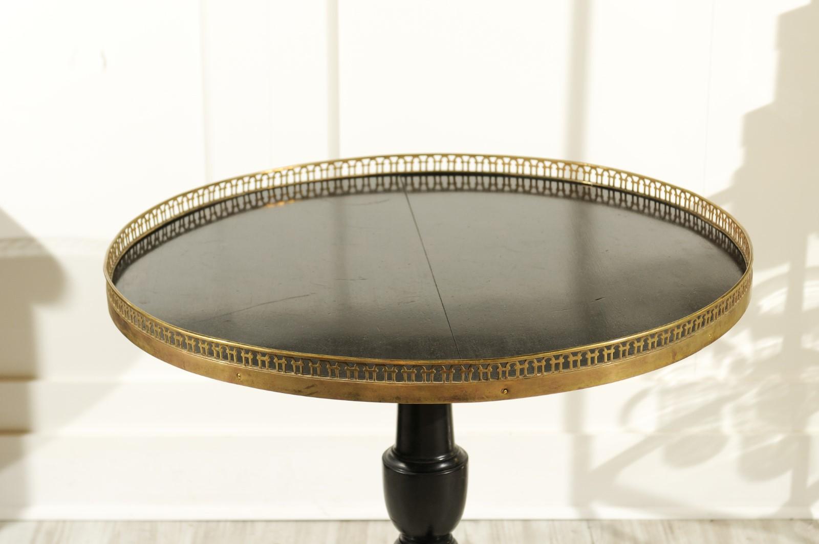 20th Century French 1920s Black-Painted Pedestal Tilt-Top Table with Pierced Brass Gallery