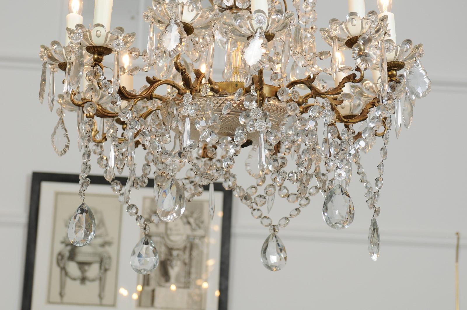 French 1920s Brass and Crystal Twelve-Light Chandelier with Scrolled Arms 6