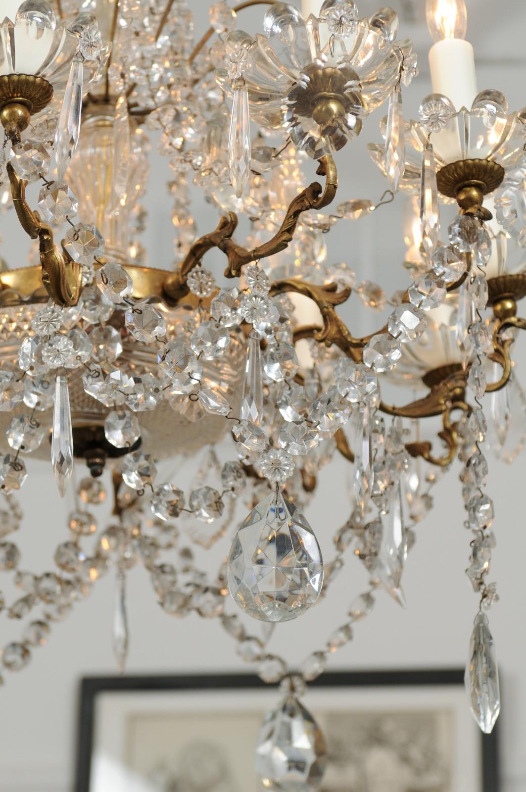 20th Century French 1920s Brass and Crystal Twelve-Light Chandelier with Scrolled Arms