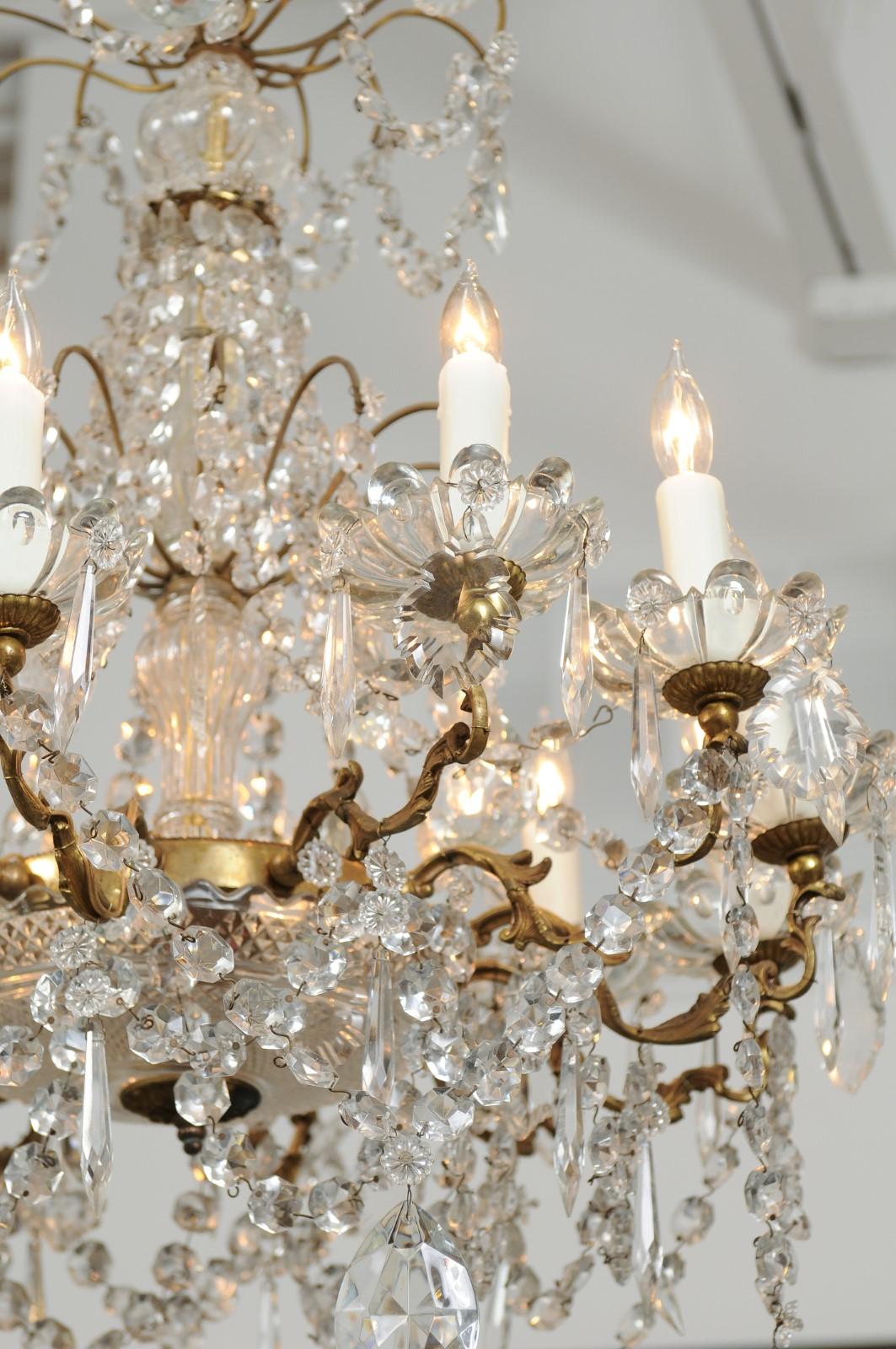French 1920s Brass and Crystal Twelve-Light Chandelier with Scrolled Arms 4