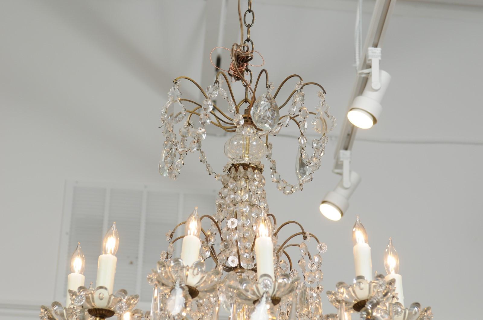 French 1920s Brass and Crystal Twelve-Light Chandelier with Scrolled Arms 5