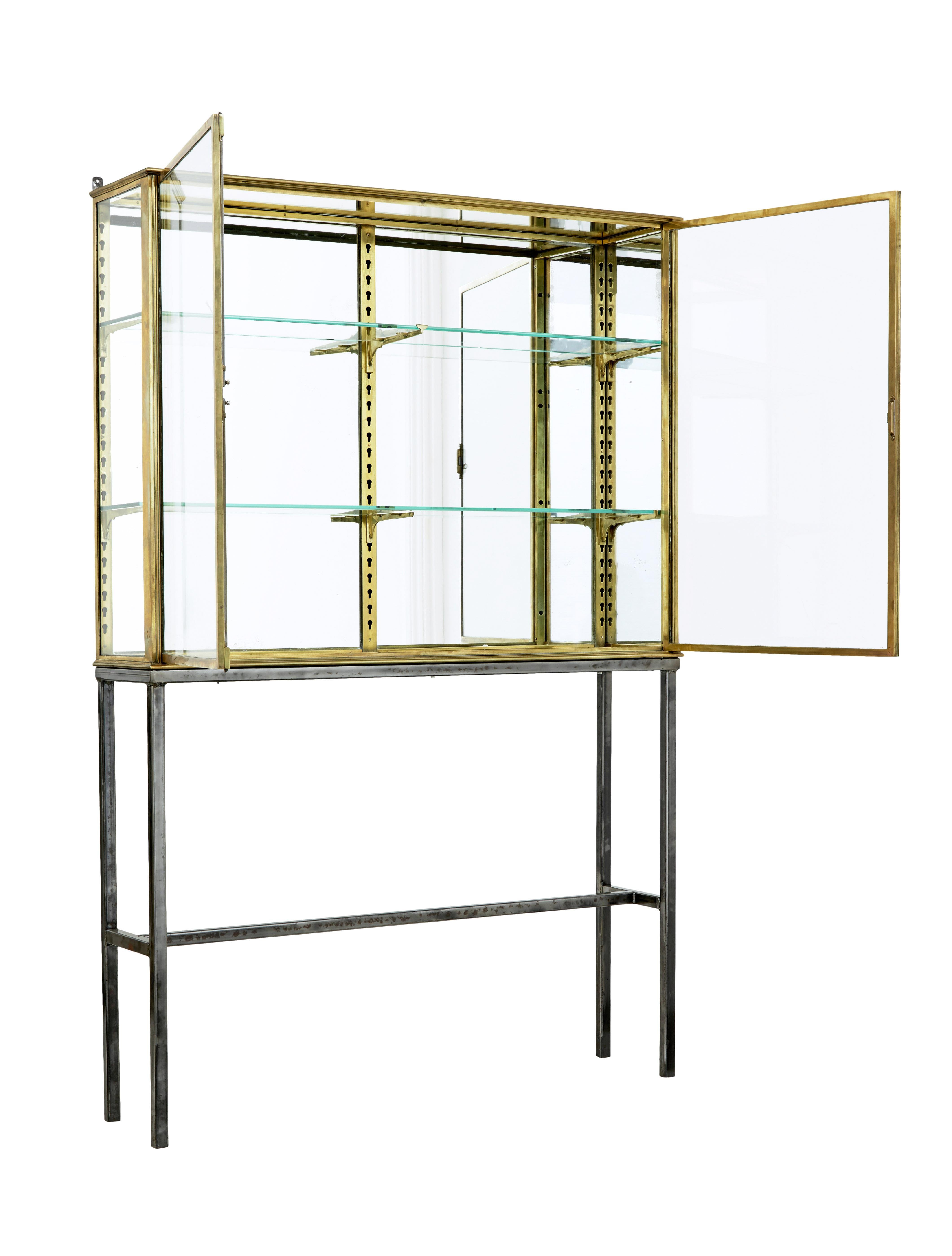 French 1920's brass glazed shop display cabinet by siegel circa 1920.

Fine piece of cabinet making by well known Parisian maker Siegel.  Solid brass frame glazed to the left and mirrored panel to the right.  Fitted with movable brackets to