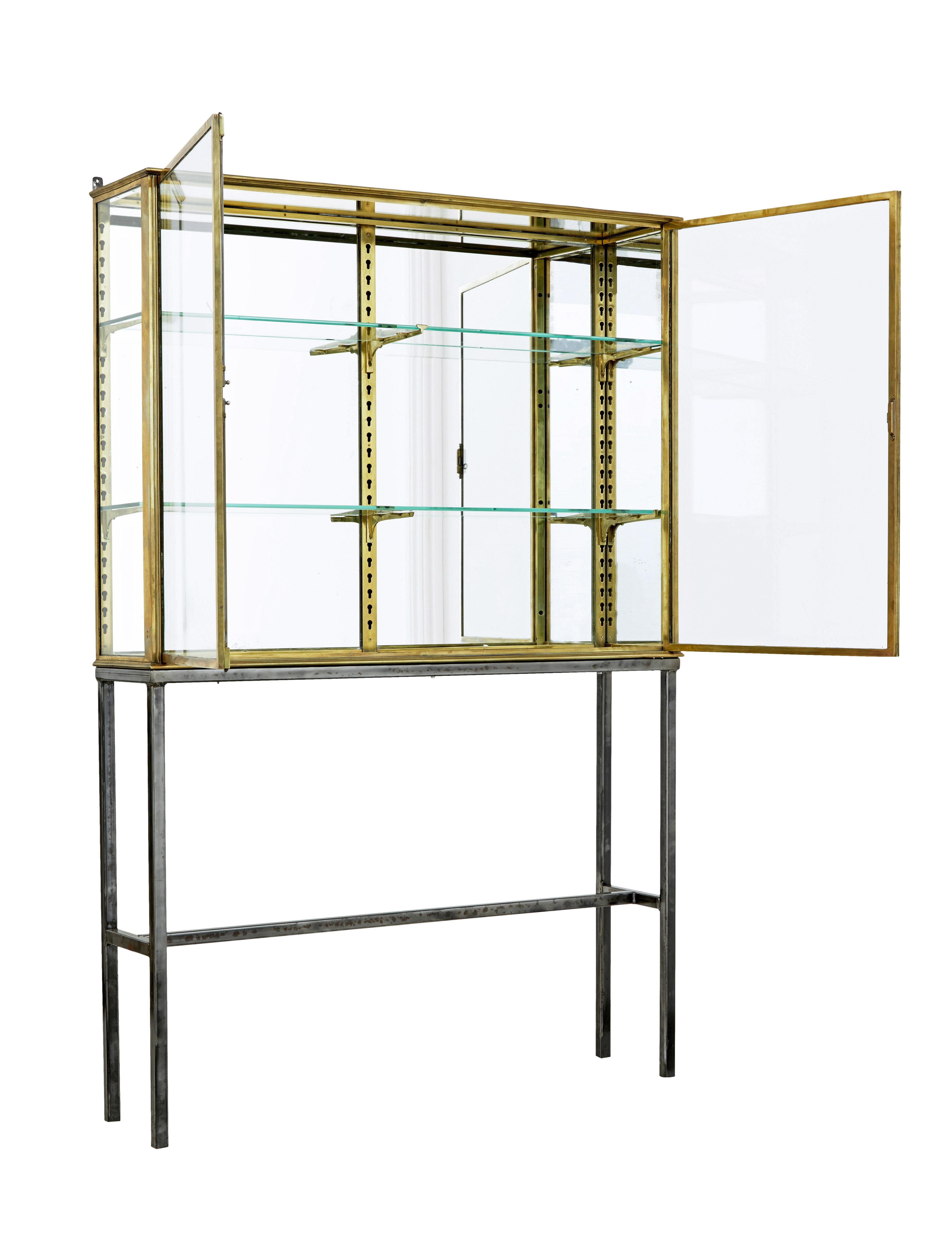 French 1920's brass glazed shop display cabinet by Siegel circa 1920.

Fine piece of cabinet making by well known Parisian maker siegel.  Solid brass frame glazed to the left and mirrored panel to the right.  Fitted with movable brackets to