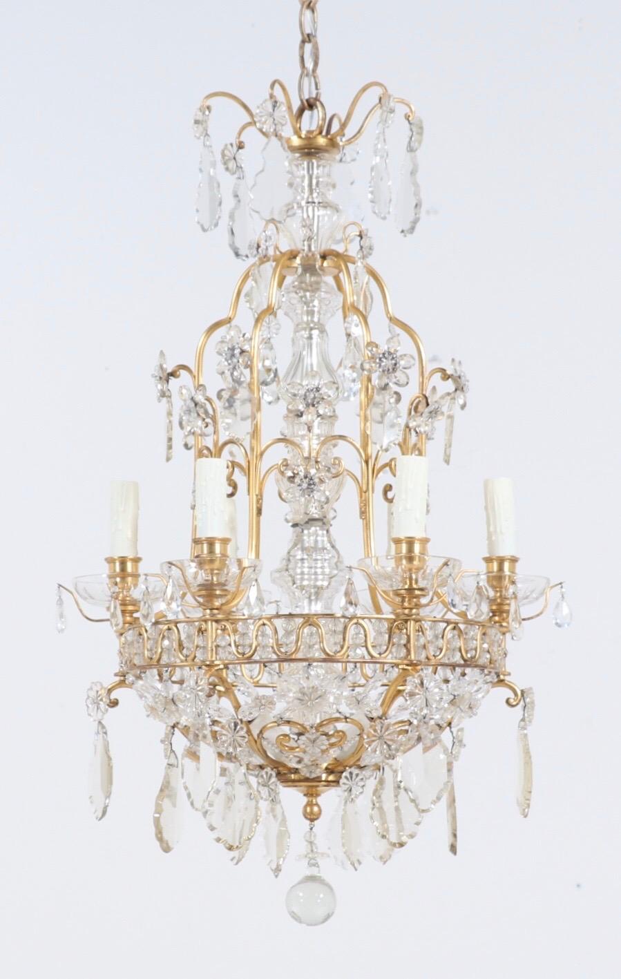 A fine, 1920s French bronze and crystal chandelier in the neoclassical style. 

This amazing chandelier consists of a delicately scrolled bronze doré frame in a basket form. The doré finish has slightly worn off over the decades. The frame is