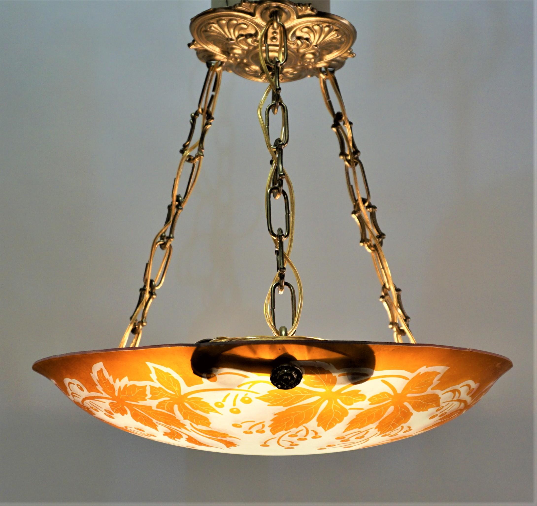 Beautiful acid cut cameo glass six light chandelier with bronze hardware.