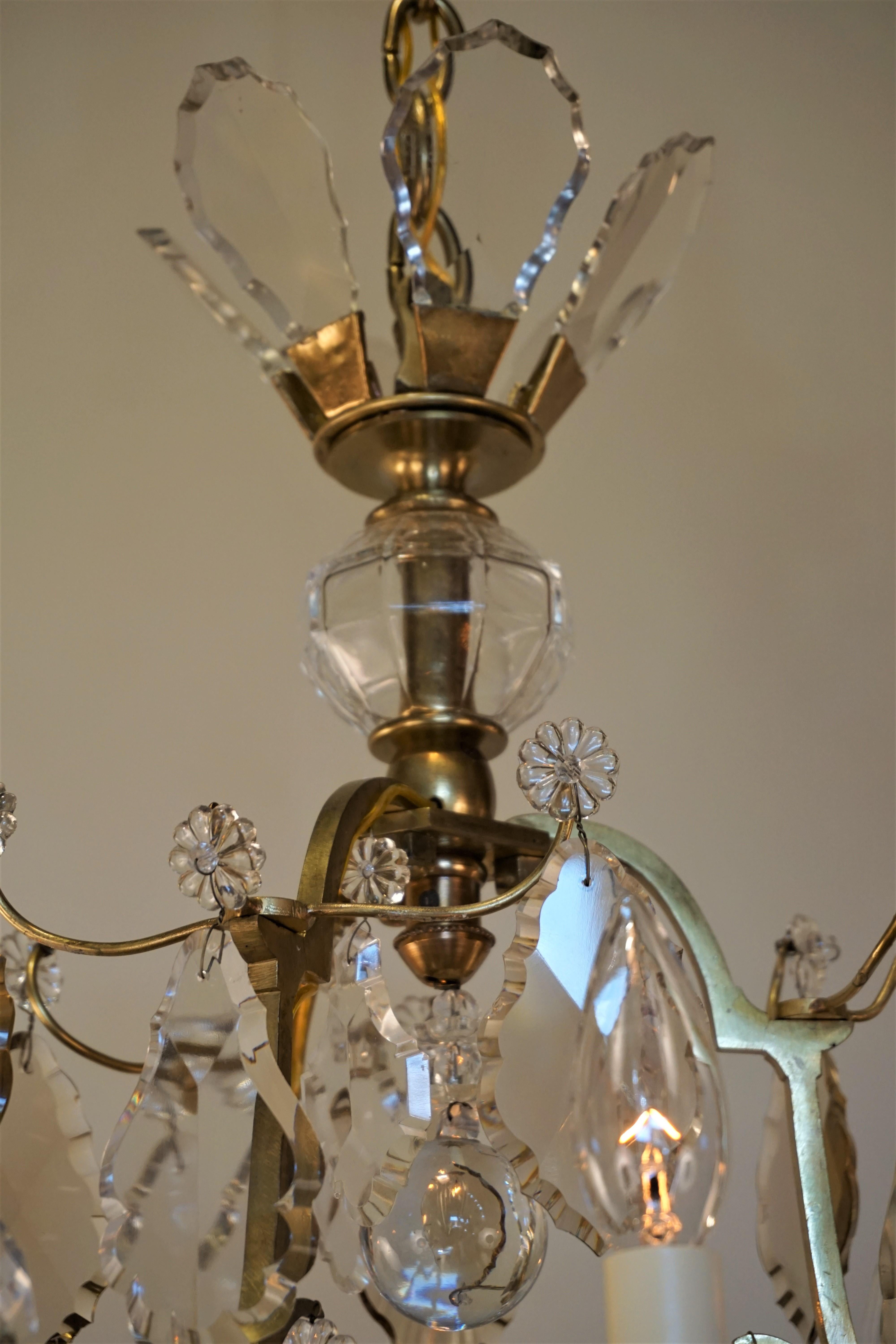 A fabulous seven-light chandelier. Made in France during the 1930s, this elegant chandelier features a classic bronze and crystal design.
Total height with all the chain is 51