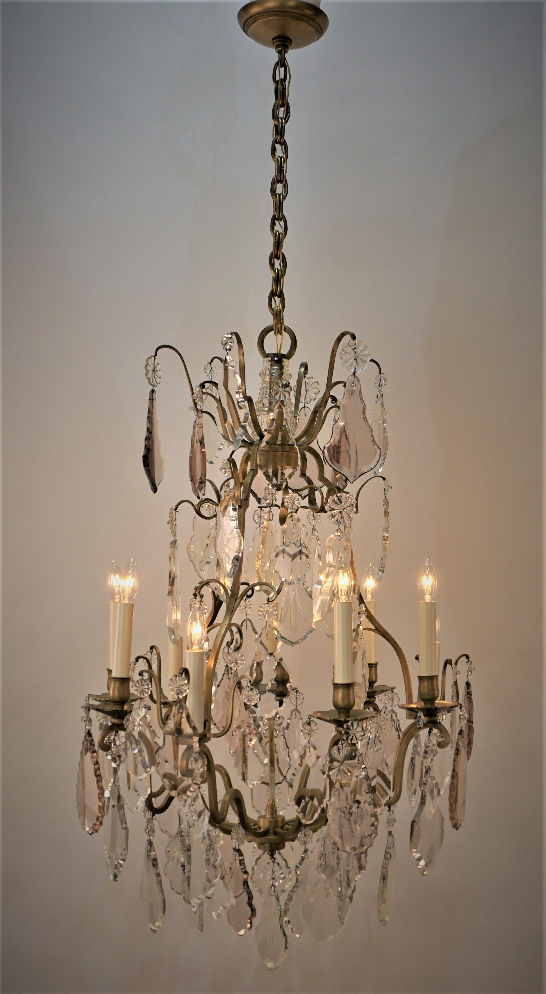 Elegant nine light hand polished clear, light smoked pink crystal and bronze chandelier.
60 Watts max each light.
Measures: 22