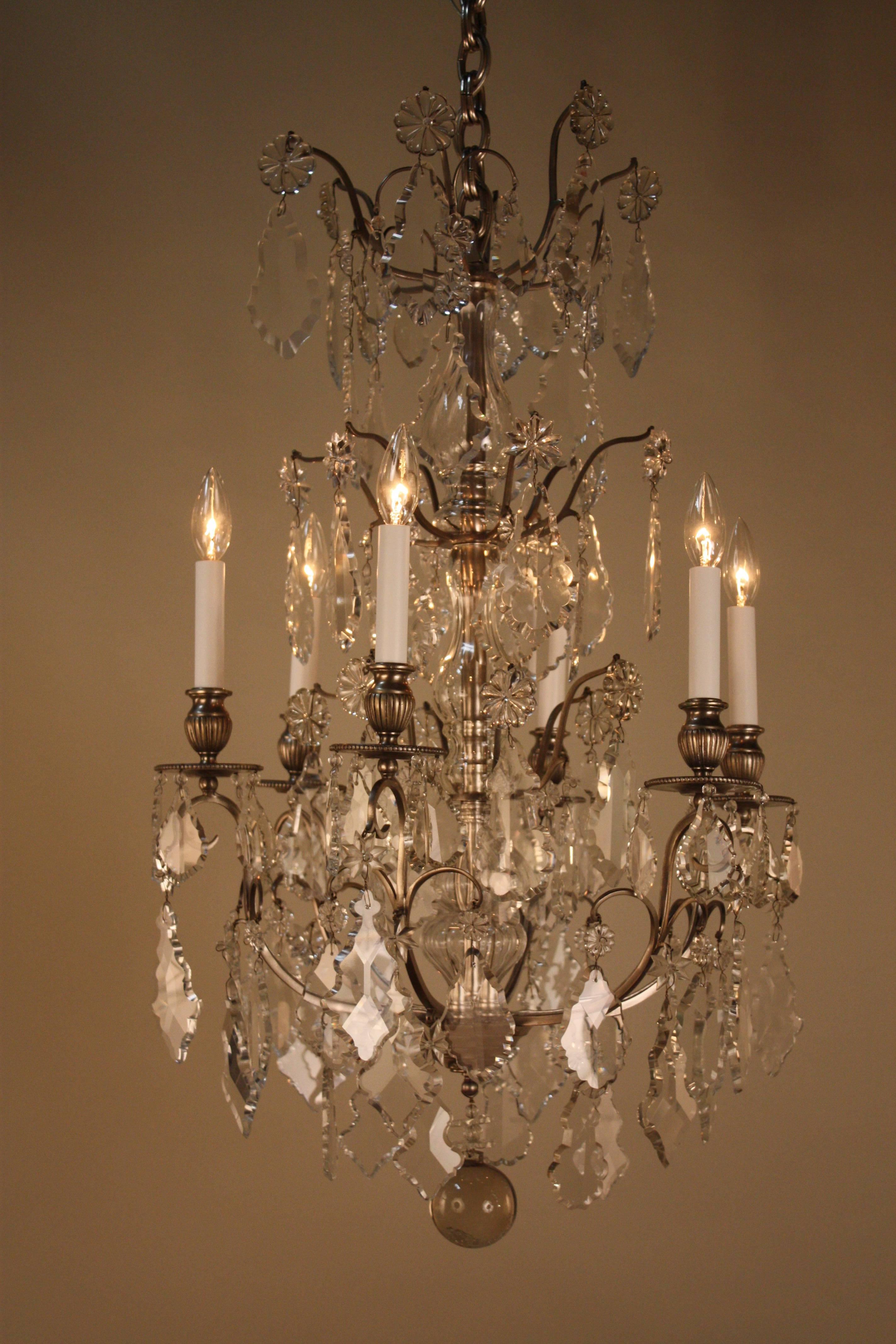 Classic French 1920s crystal and silver on bronze chandelier.