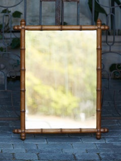 French 1920s Faux Bamboo Walnut Mirror with Protruding Corners and Brown Patina