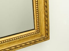 French 1920s Giltwood Split Glass Mirror with Twisted Ribbon and Beaded Motifs