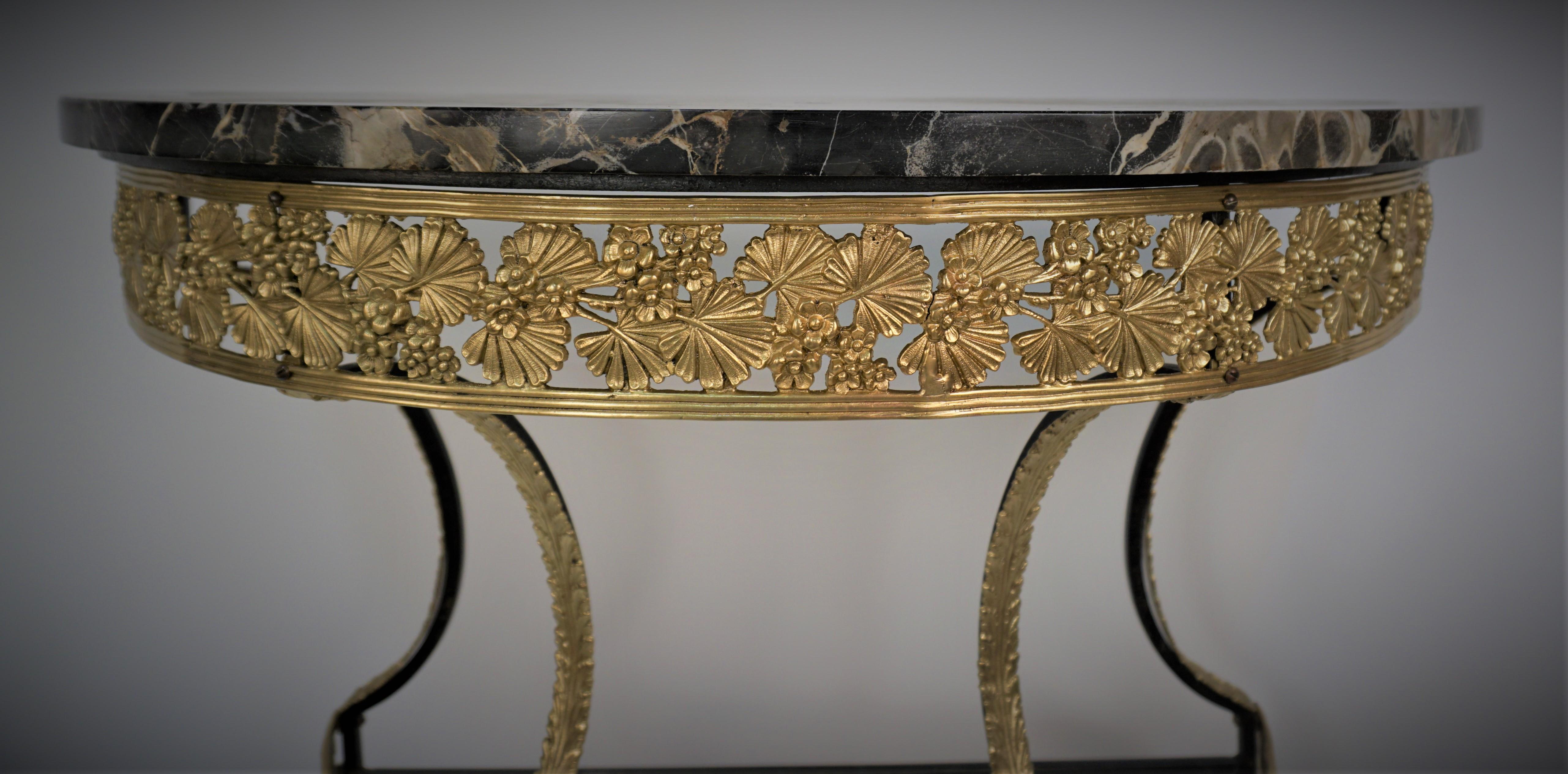 Beautiful 1920's Kingo leaf design bronze iron base with marble top demilune console wall table.