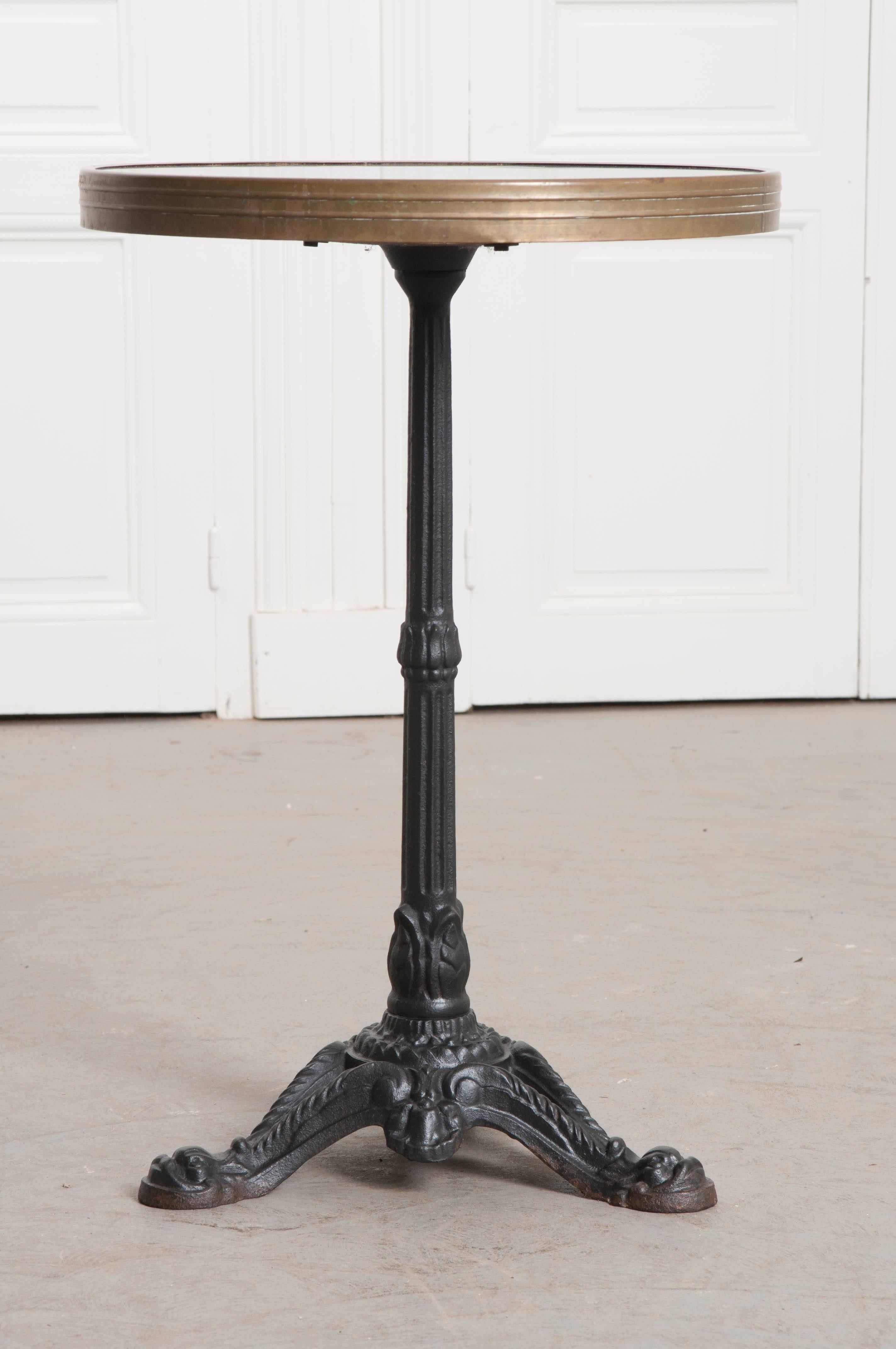 A Classic 1920s French bistro table, done in black. The round top is Bakelite, an early plastic dating back to 1907. It is, in fact, the world’s first synthetic plastic. The wonderfully patinated top is surrounded by a simply styled brass band that