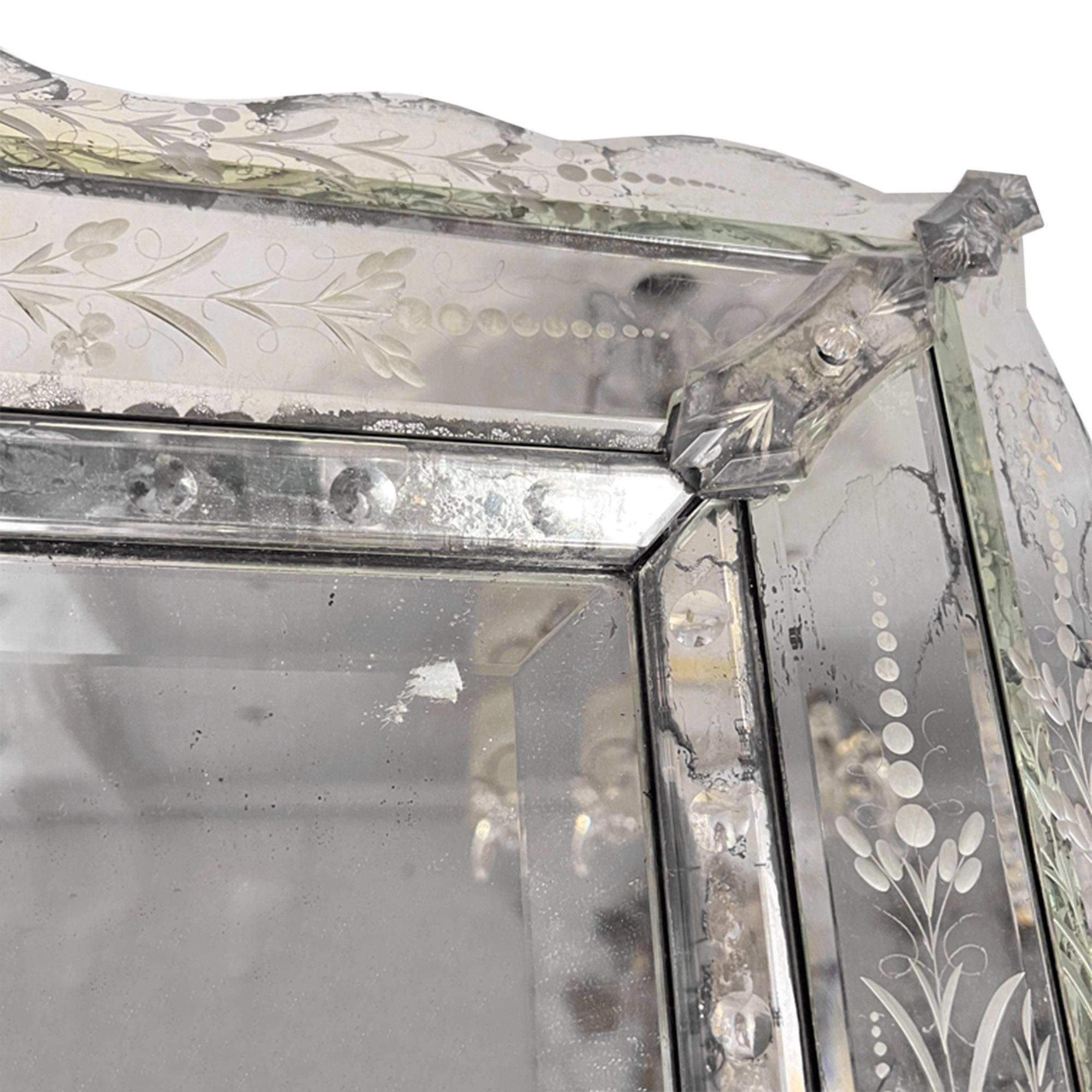 An absolutely stunning mirror made in France in the Venetian style in the 1920s.

Please take a look at all the pictures to see the detail on the frame, the bevelled edge of the main piece of mirror and where the glass is foxed.

This mirror can be