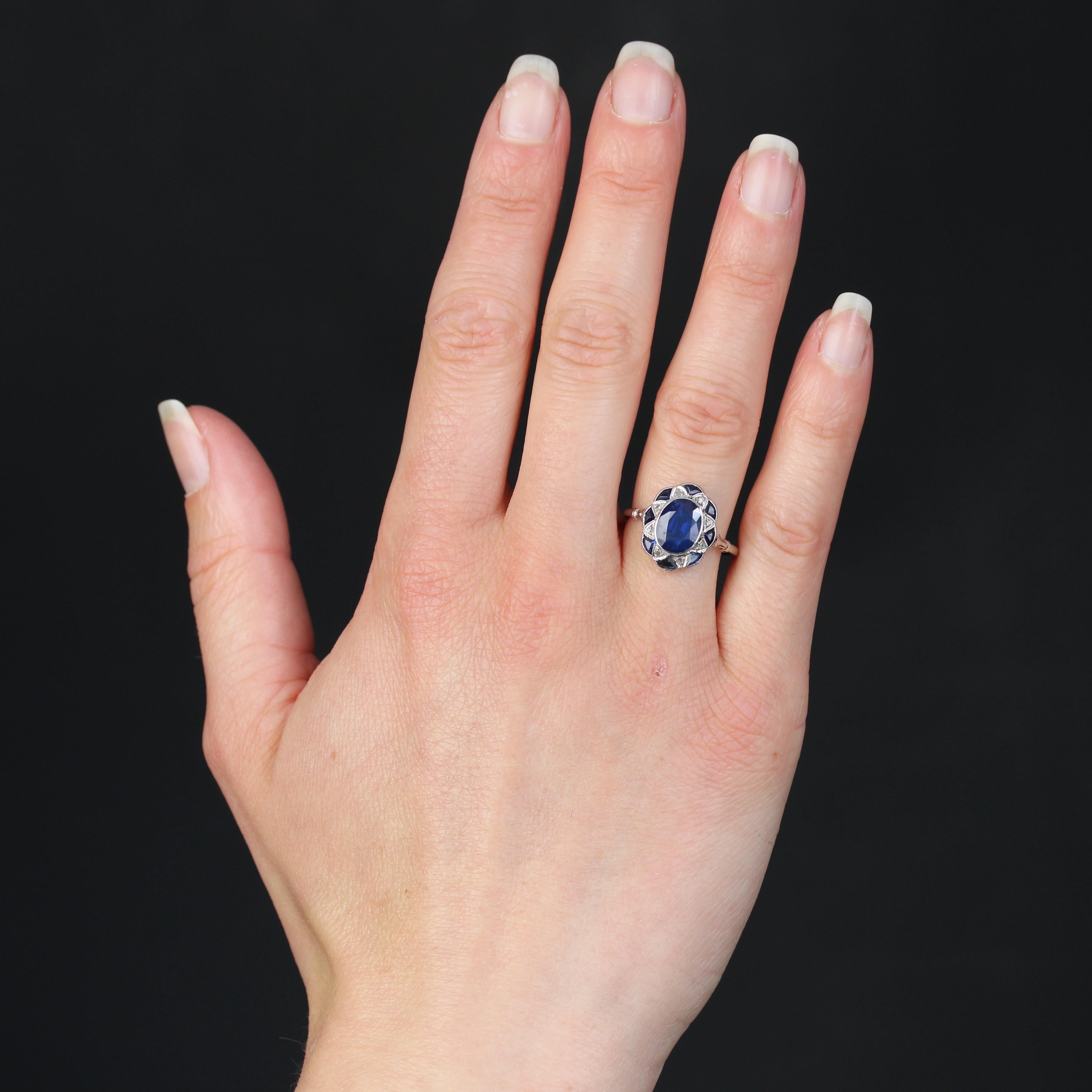 Ring in 18 Karat white gold, eagle head hallmark and platinum, dog head hallmark.
Magnificent oval-shaped antique ring set with a flower motif, the center of which is set with an oval sapphire and the surround with a star motif set with small