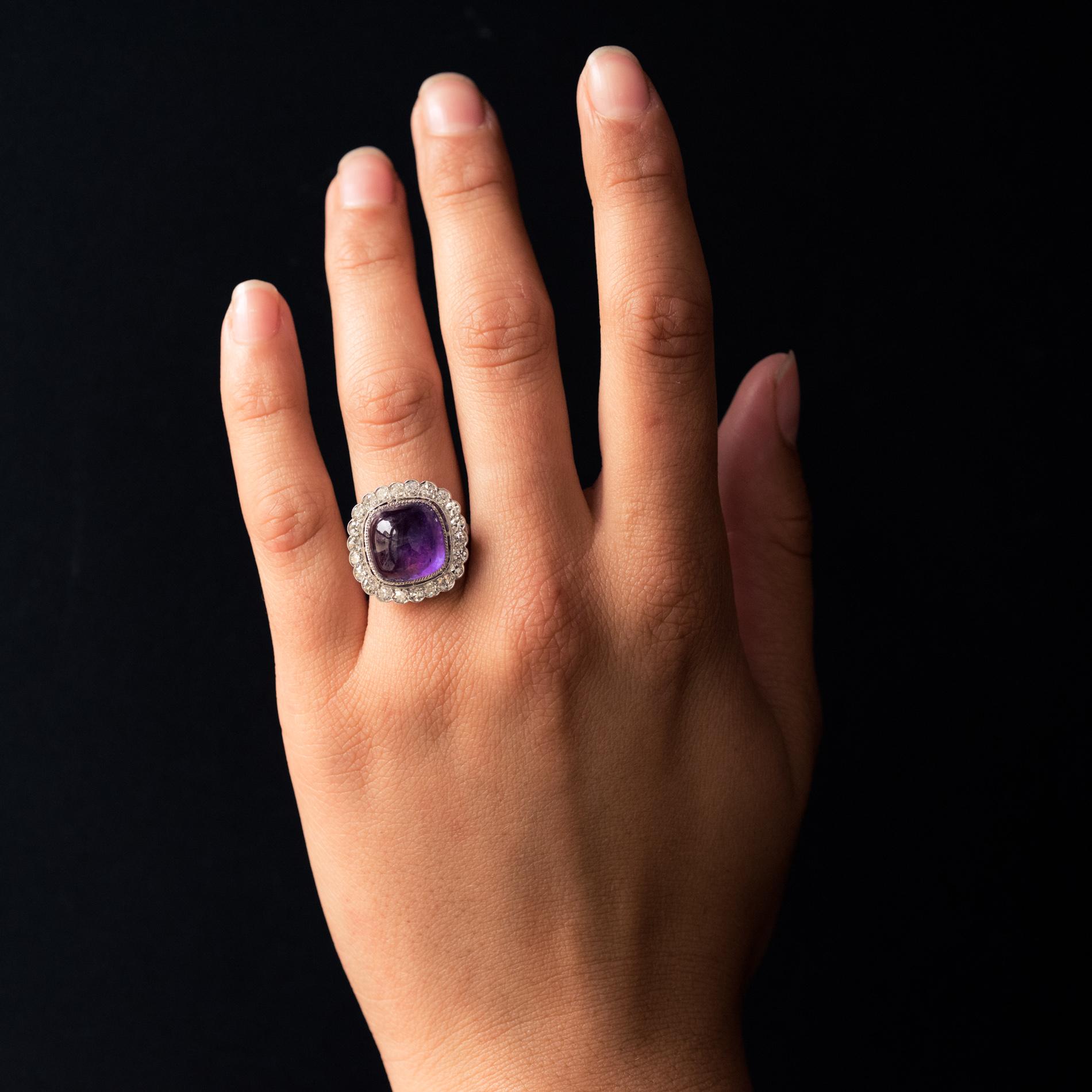 Ring in platinum, dog's head hallmark.
Sublime art deco ring, it is closed set with millegrains in the center of a sugarloaf amethyst, in an entourage of 8/8 cut diamonds. On both sides of the head, on the departure of the ring, are set 2x3 rose-