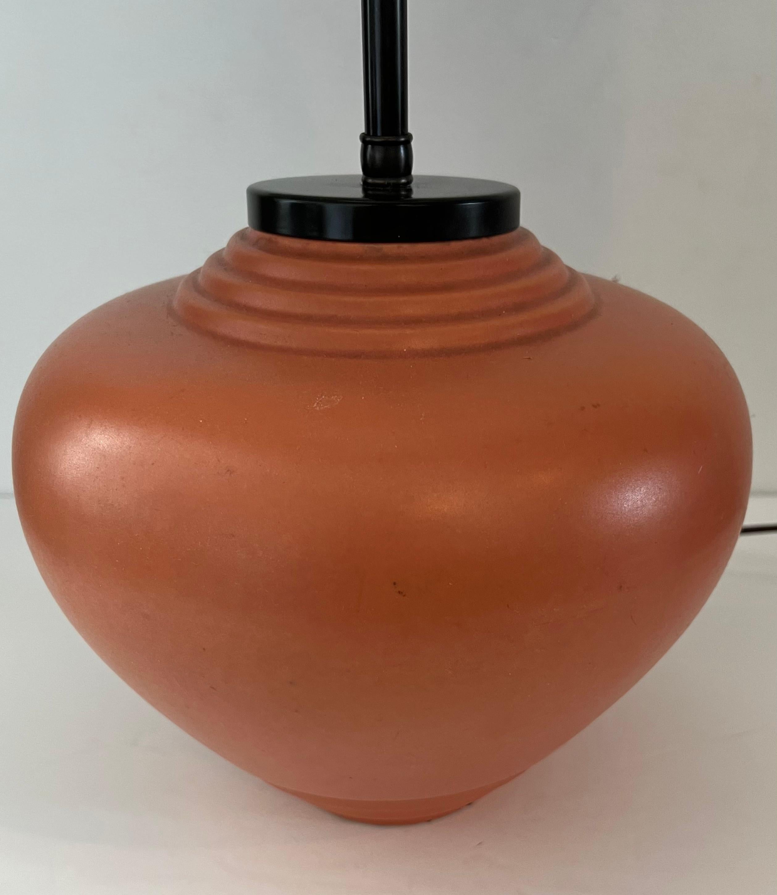 An original French Art Deco ceramic ovoid table lamp with dark aged bronze double sockets. Rewired with brown silk cord. Signed. Ceramic vase measures 8.5 H x 8” W. Shade can be included but must pay for a second shipping box.