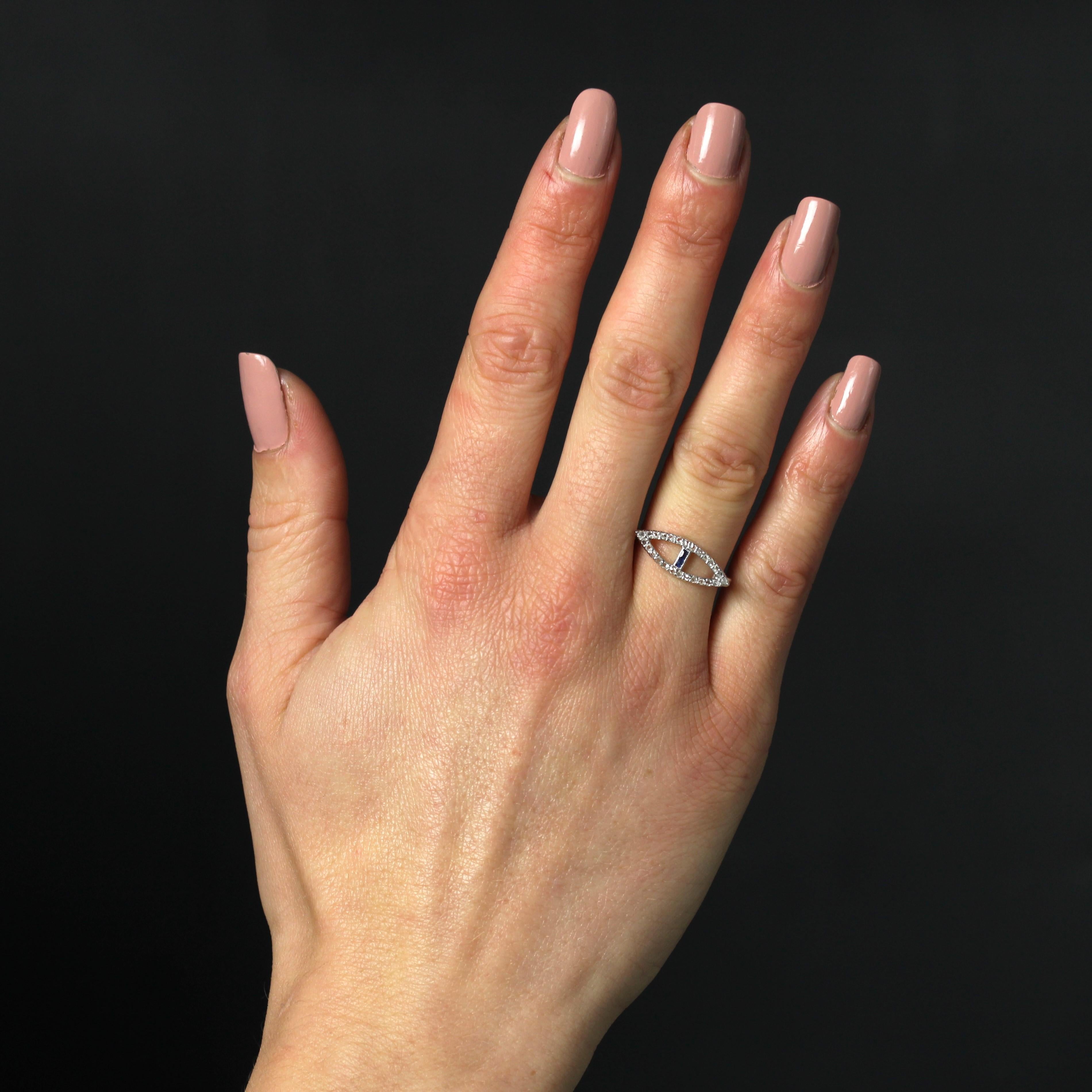Ring in 18 Karat white gold, eagle head hallmark and platinum, dog head hallmark.
This original antique ring features a navette-shaped motif entirely set with rose-cut diamonds, openworked and set in the center with 2 calibrated blue gems.
Height :