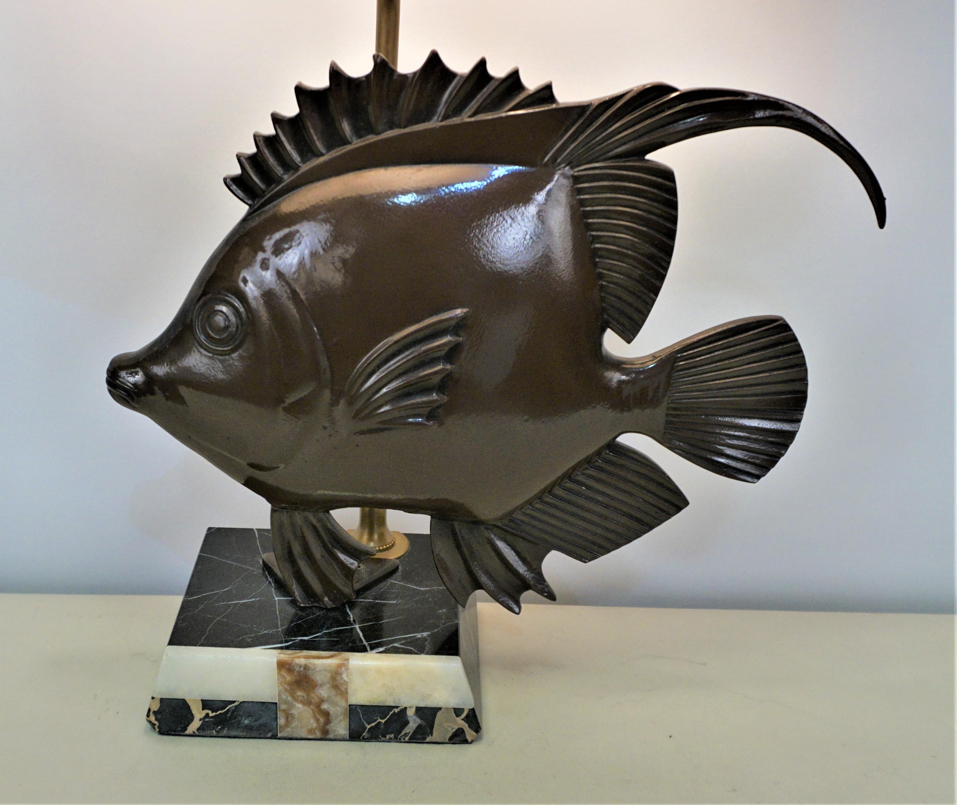 Bronze fish cold paint finish sitting on marble base with new cut corner oval lampshade.